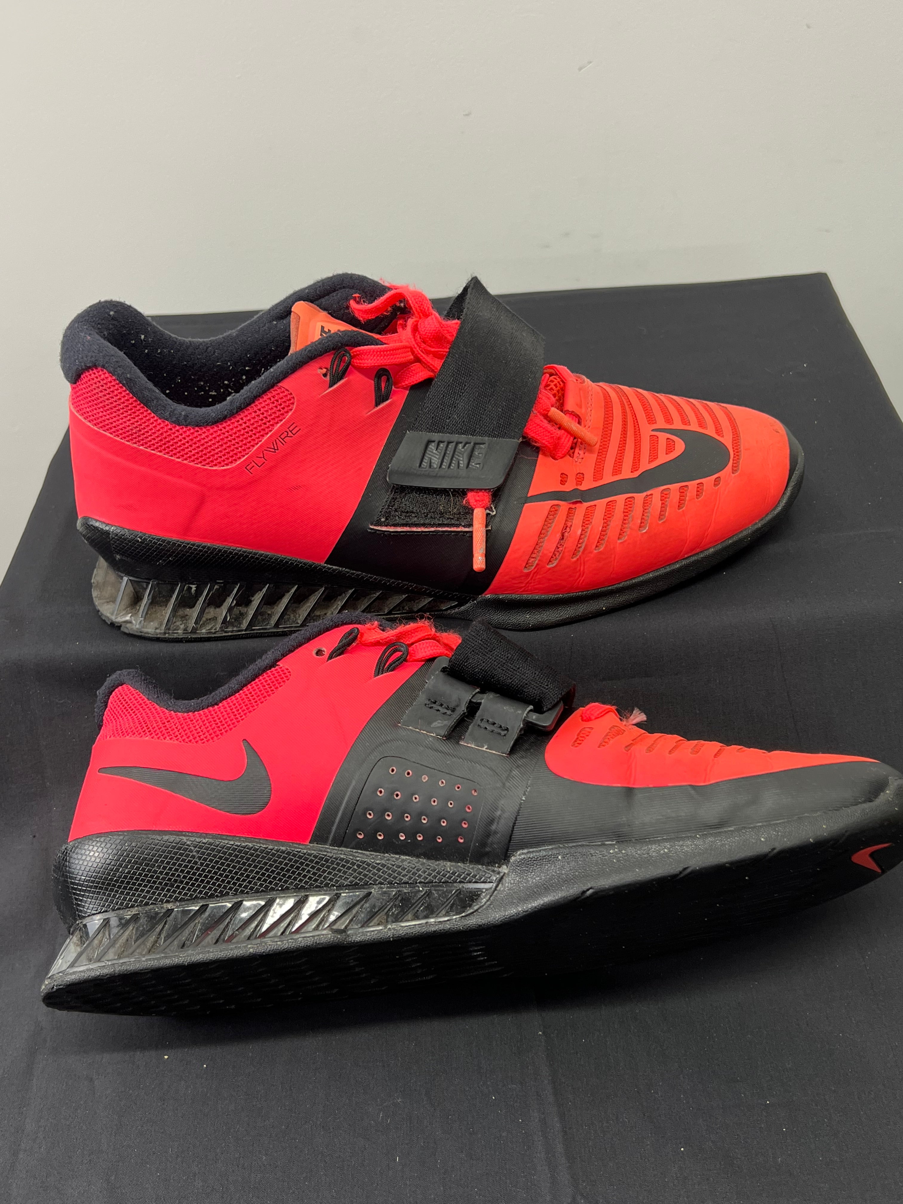 Side view of Nike Romaleos 3 weightlifting shoes displaying the Flywire design and sole structure with adjustable strap engaged