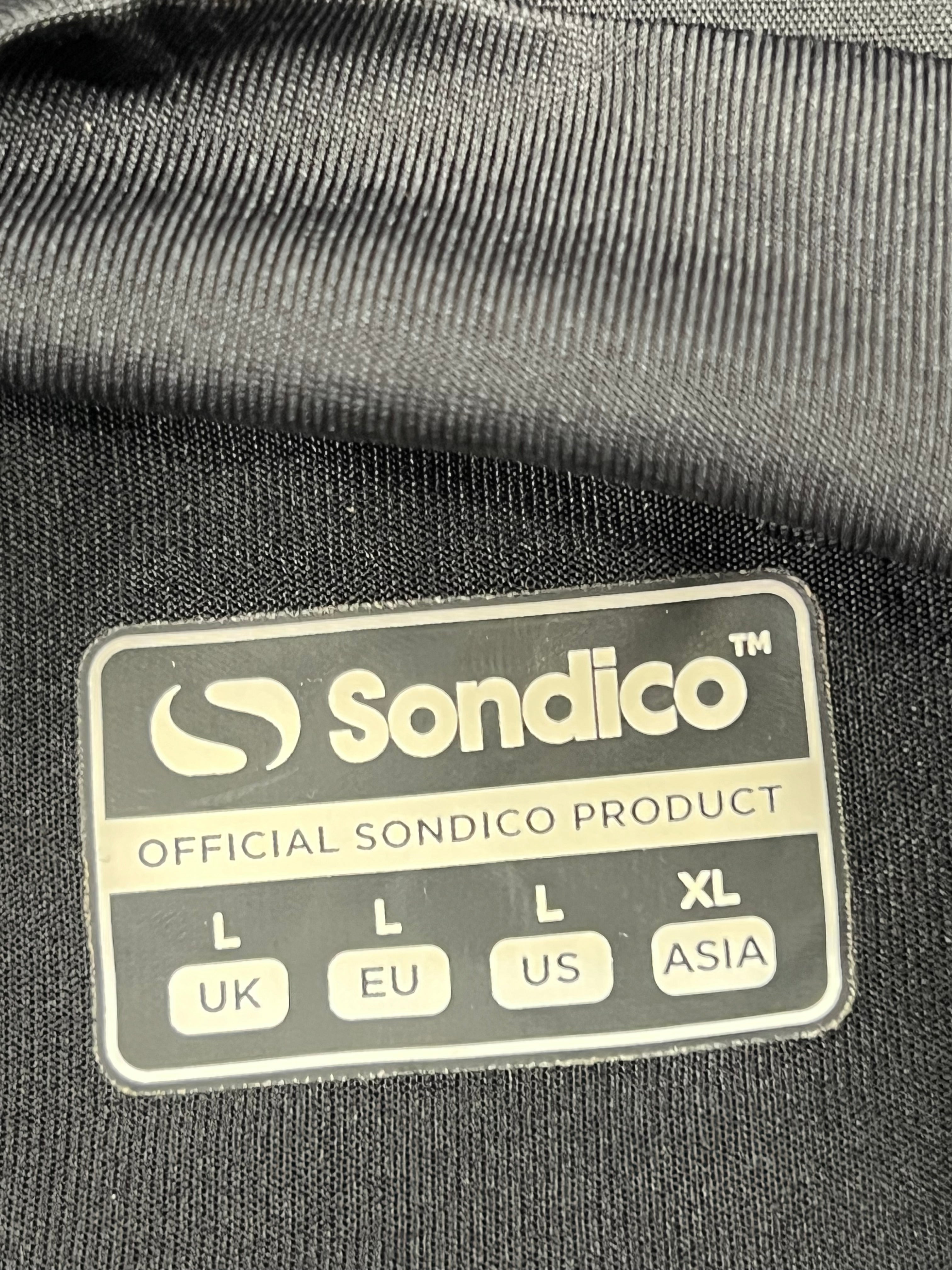 Close-up of Sondico size and brand label on black base layer fabric