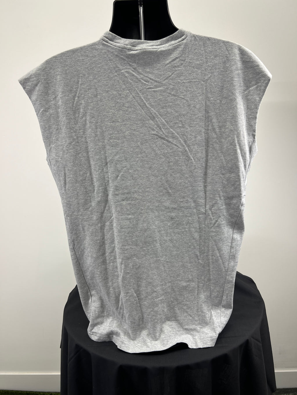 Back view of men’s grey sleeveless Gymshark top showing plain design
