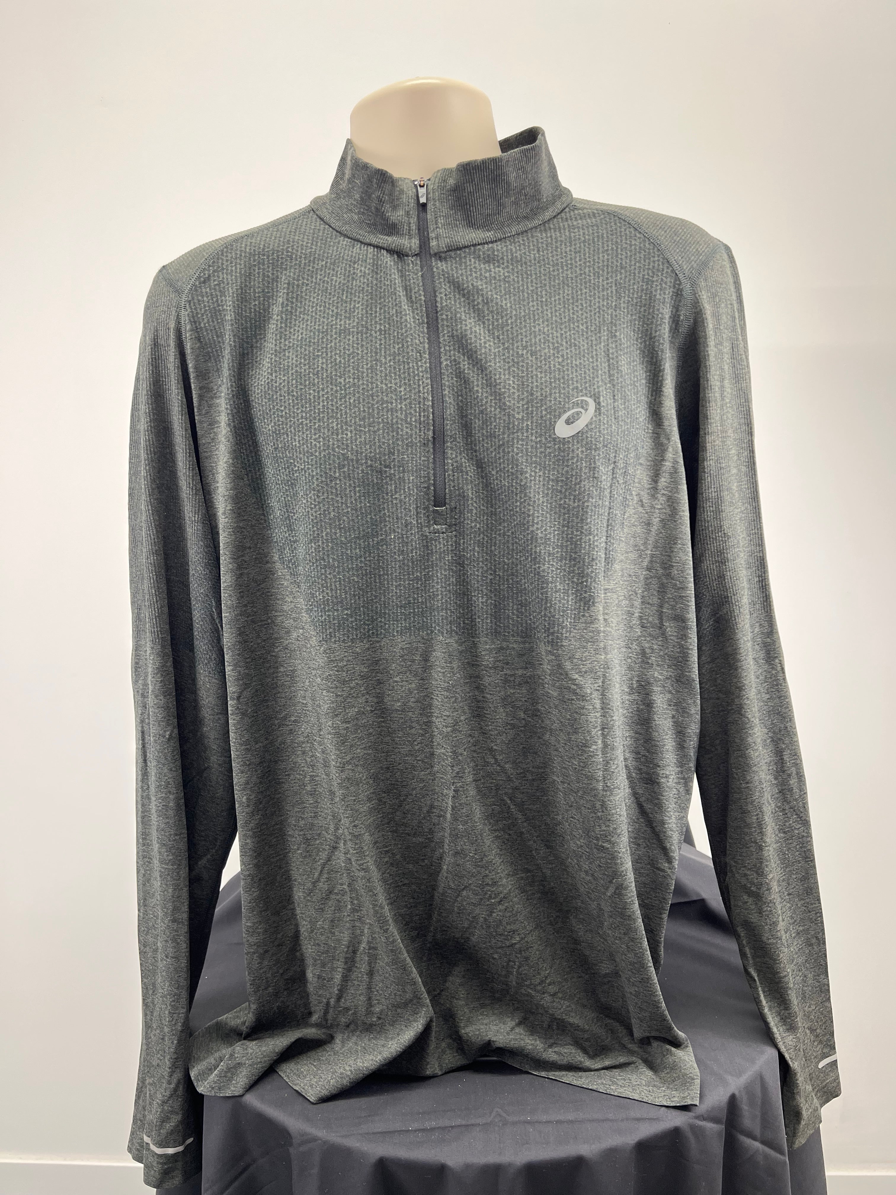 Front view of men's grey Asics long sleeve performance top with half-zip and subtle pattern