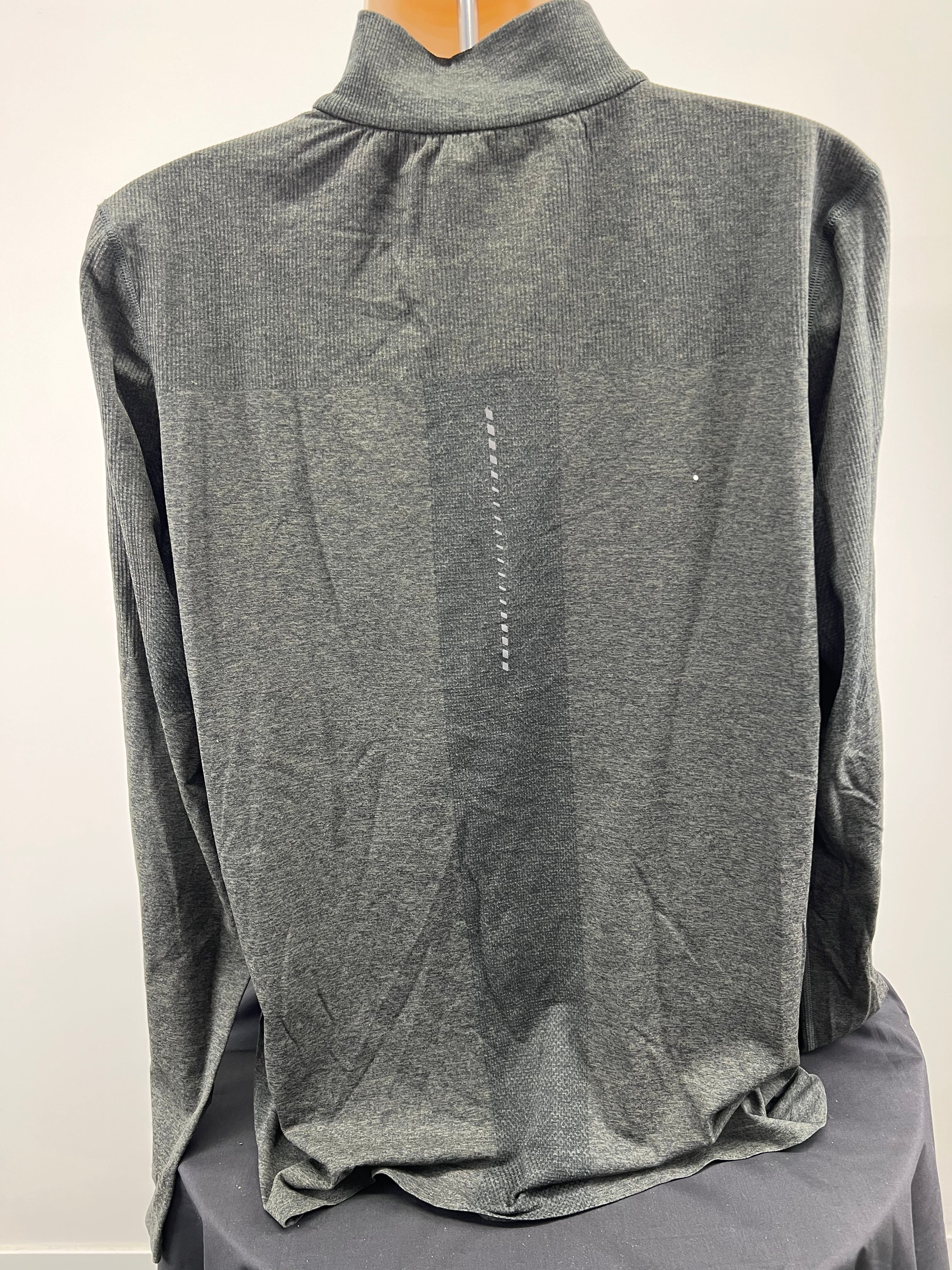 Back view of men's grey Asics long sleeve top showing textured design and reflective vertical detail