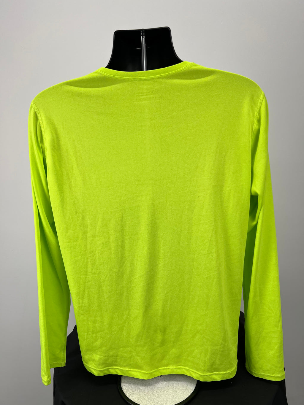 Back view of neon yellow Ronhill long sleeve running top on mannequin