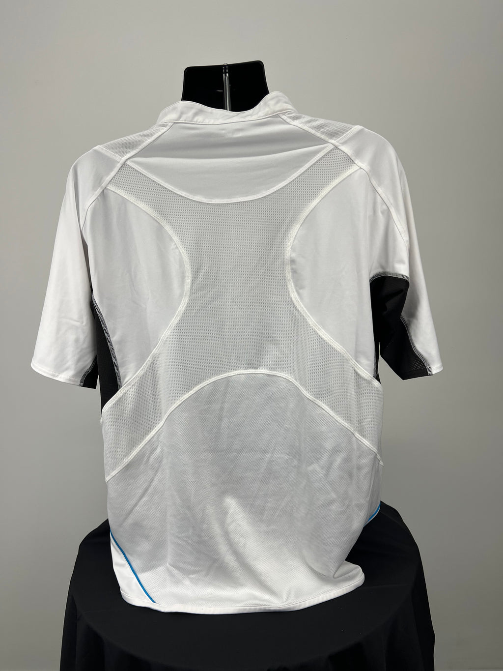 Back view of Wilson white sports top showing breathable mesh panels and black and blue accents
