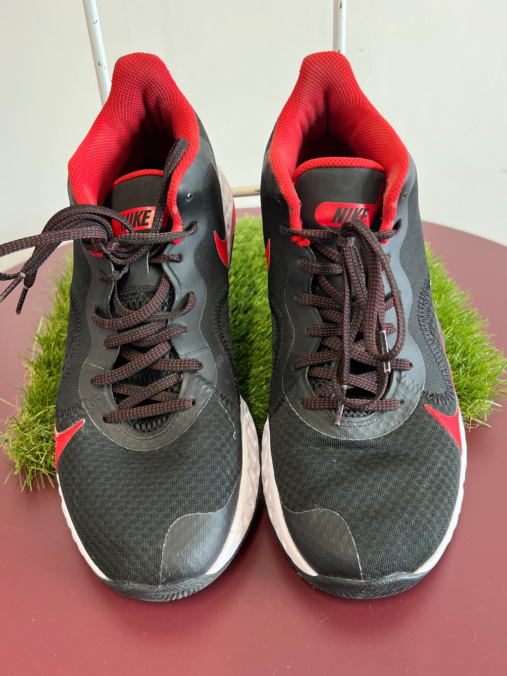 Top view of black and red Nike Renew Elevate men's basketball trainers showing laces and mesh upper