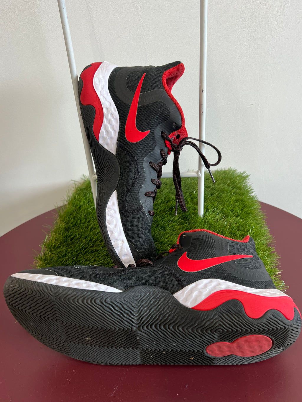 Opposite side view of Nike basketball trainers displaying red collar and textured white midsole