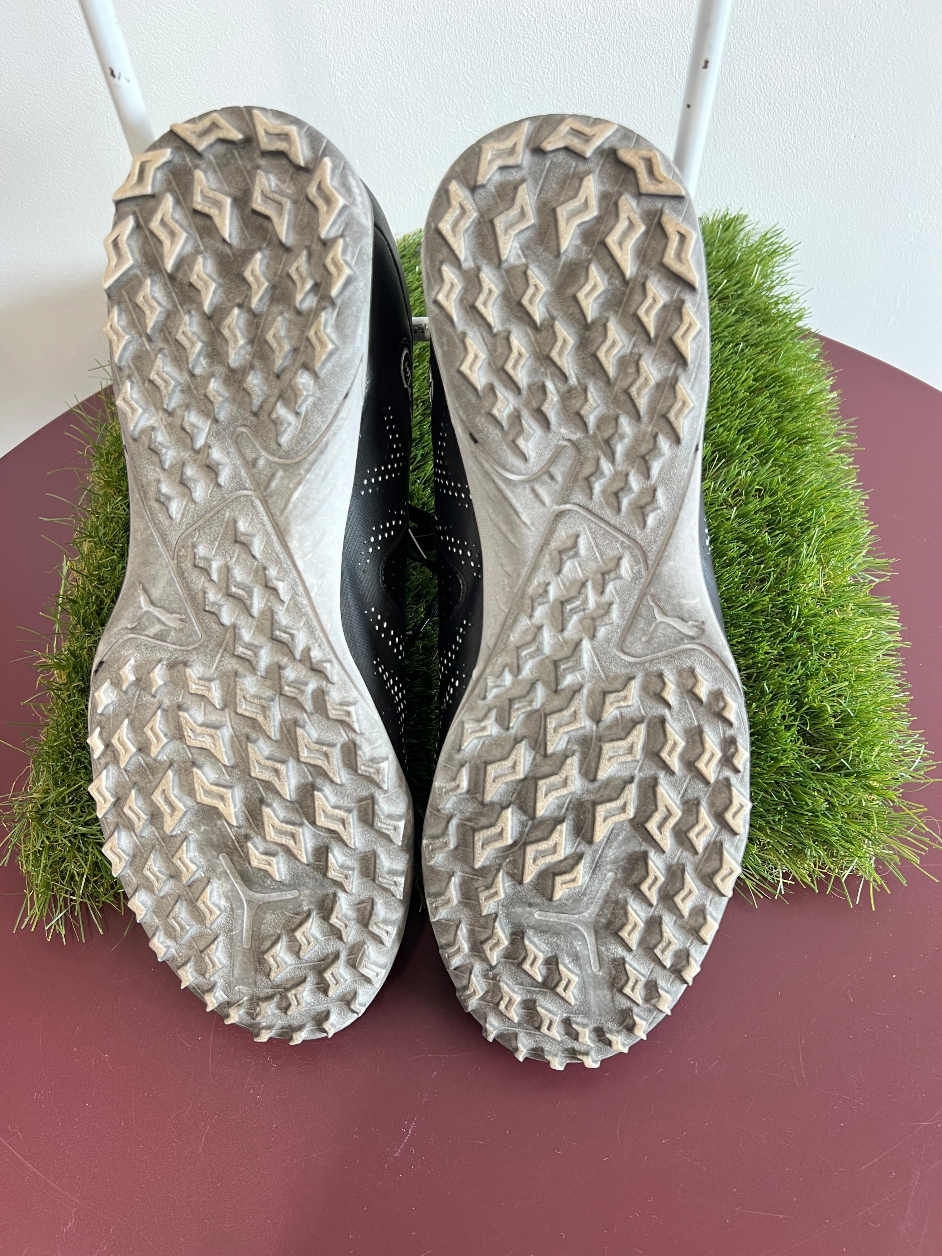 Sole view showing textured rubber studs on Puma FR2 trainers designed for turf grip