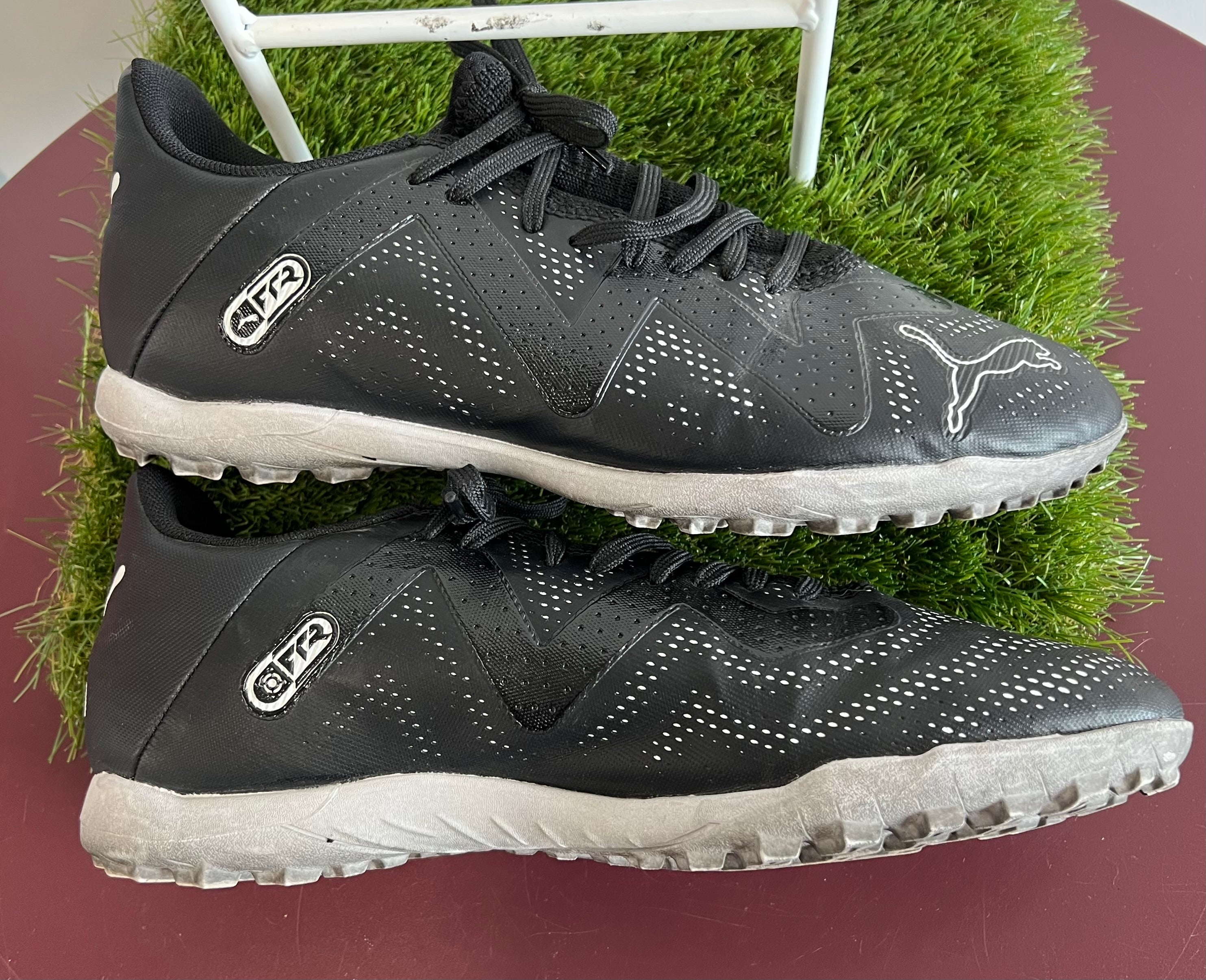 Side view of black Puma FR2 men's trainers with strap and intricate perforated design