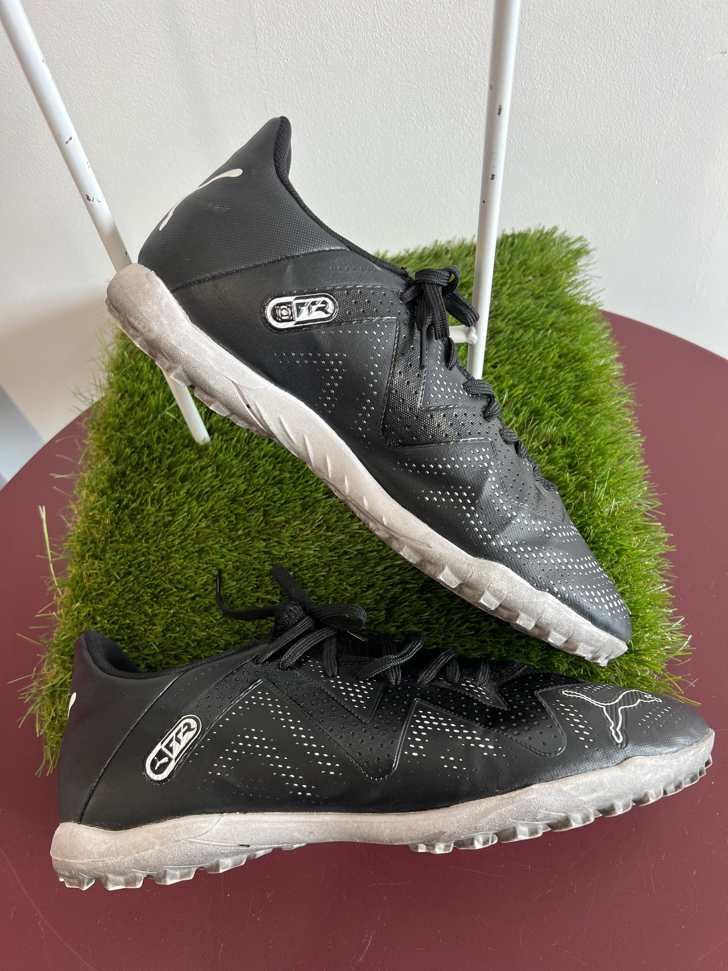 Close-up side view of Puma FR2 trainers showing iconic Puma branding and synthetic material