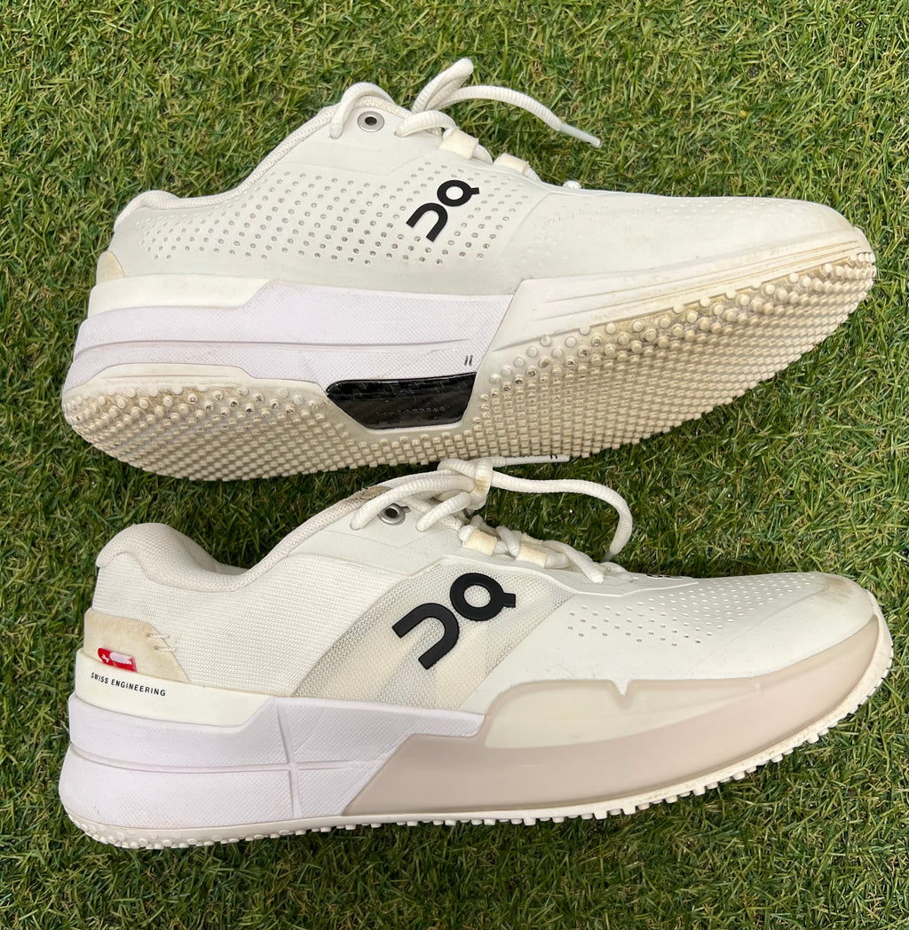 Side profile of white trainers highlighting sleek design and cushioned sole
