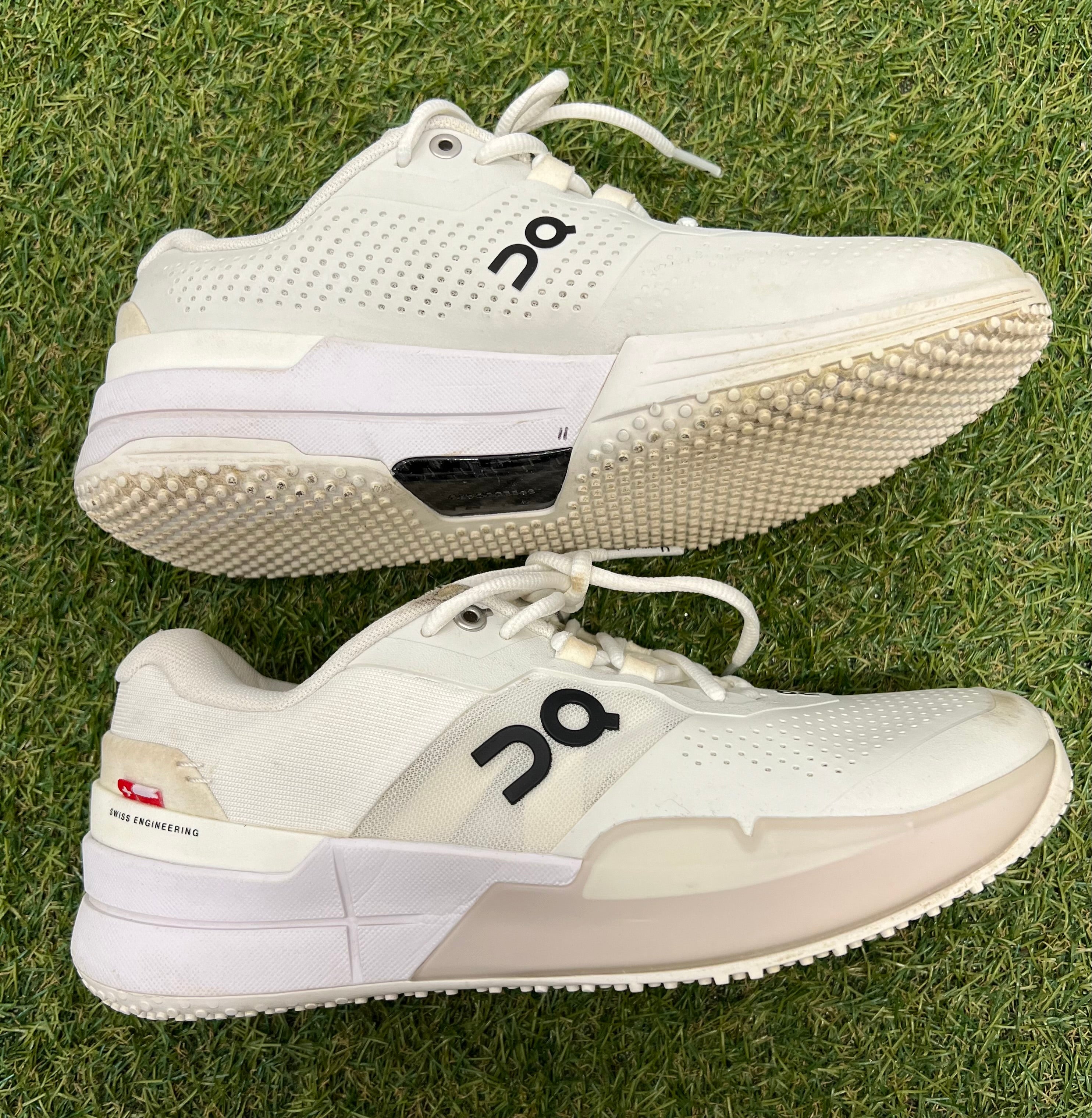 Side profile of white trainers highlighting sleek design and cushioned sole