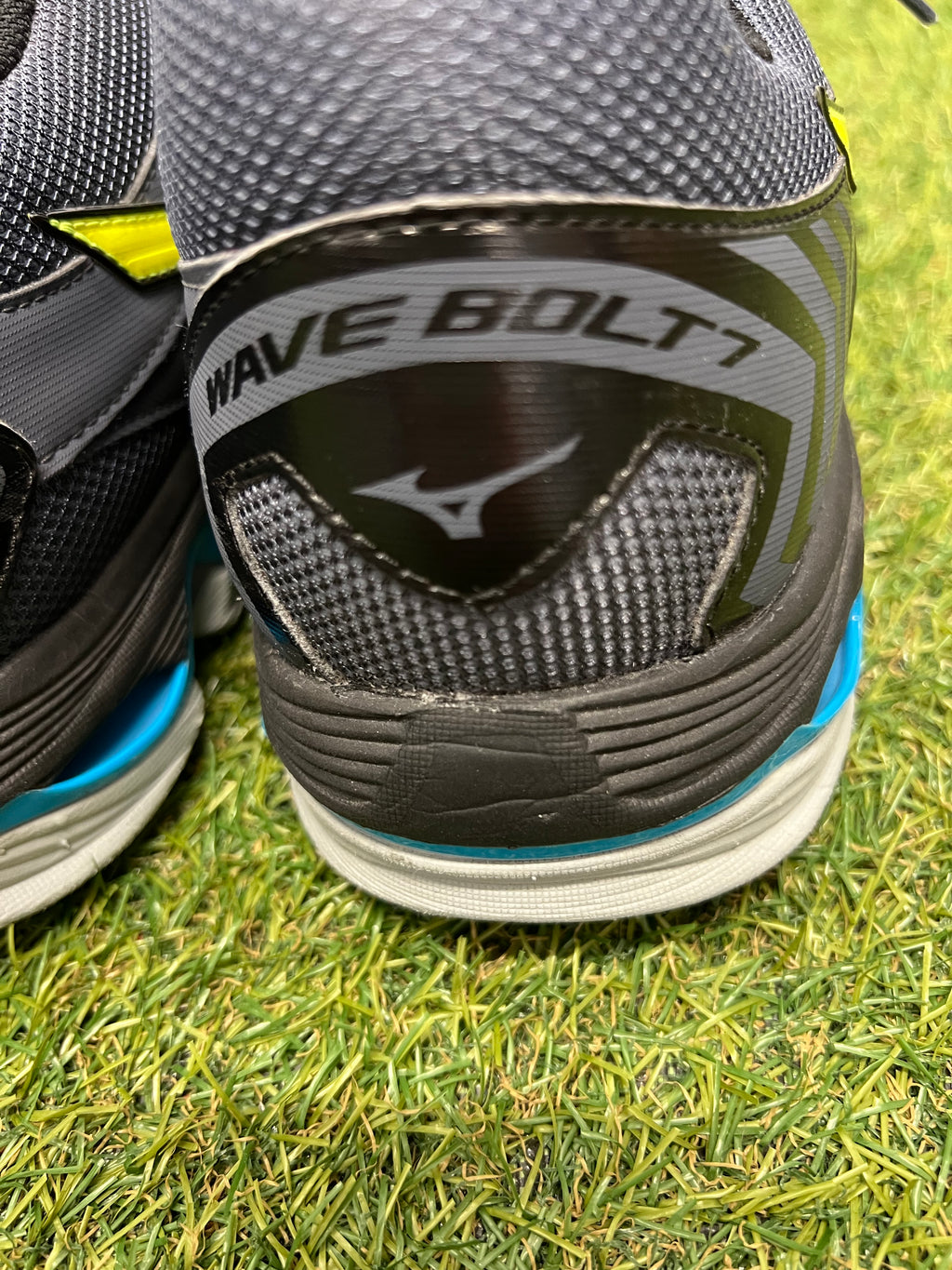 Close-up of heel section on Mizuno Wave Bolt 7 trainer with branding and textured fabric