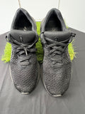 Top view of black Nike React trainers with knit fabric and laces on grass backdrop
