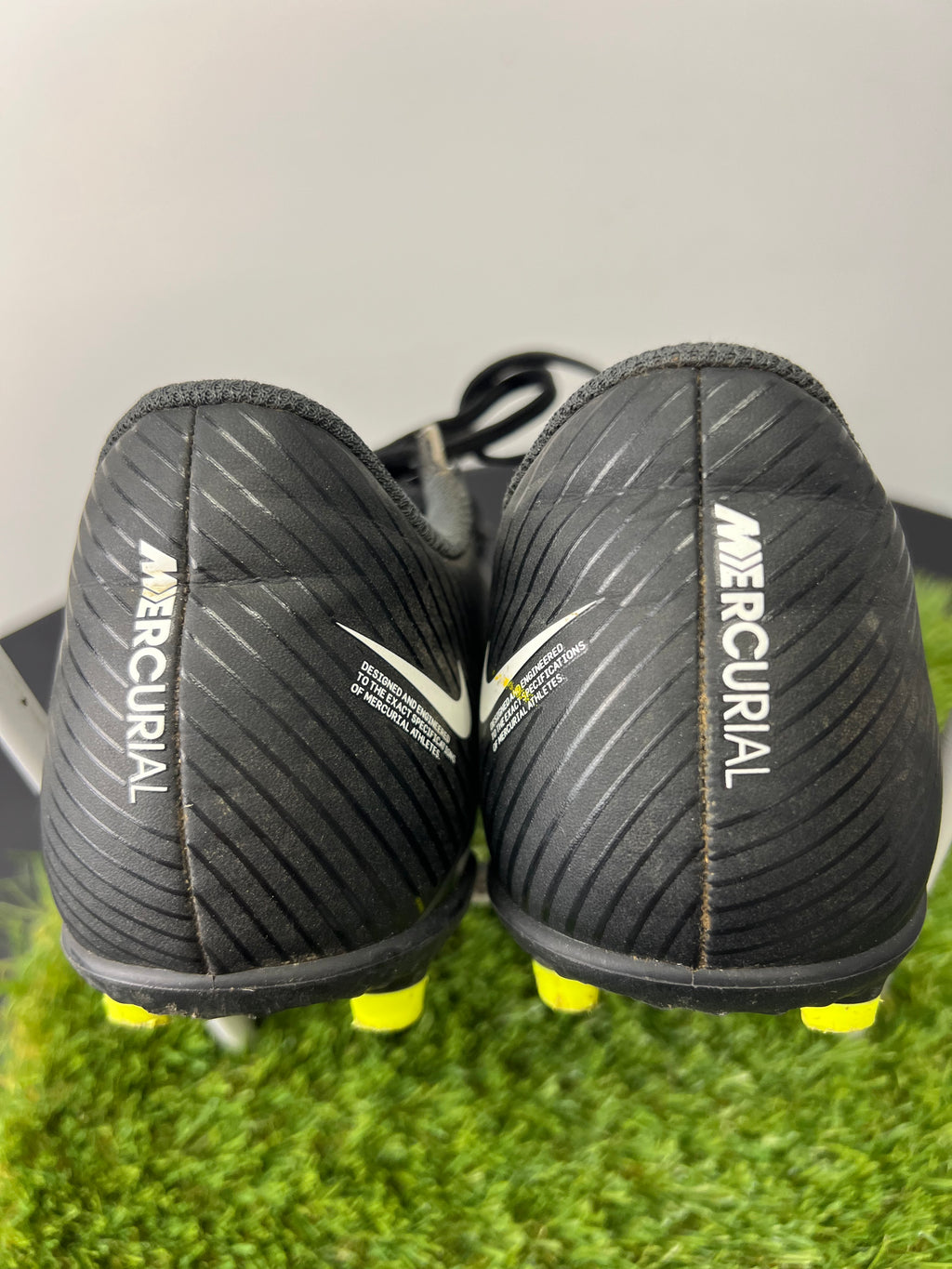 Rear view of black Nike Mercurial football boots with white Nike logo and Mercurial branding