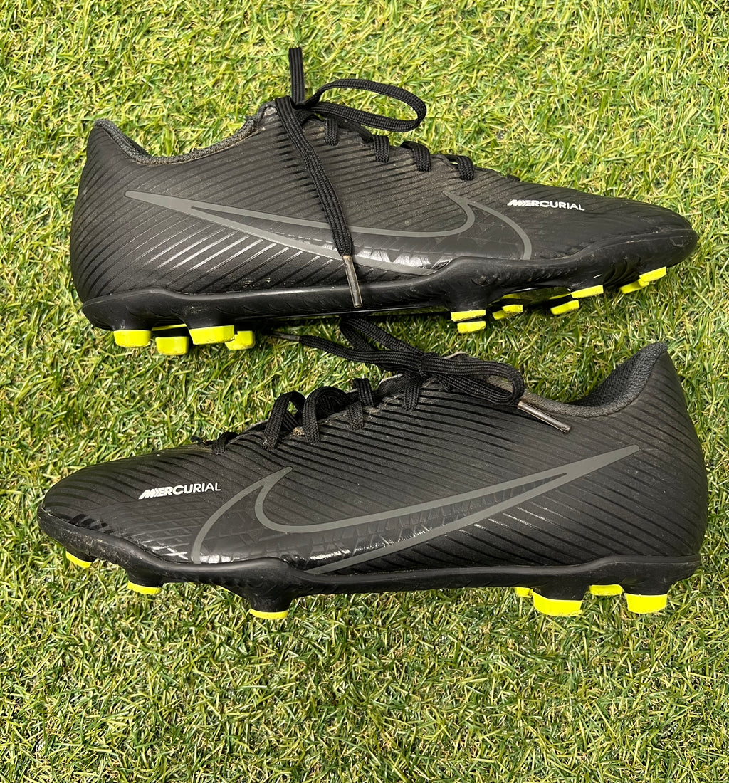 Side view of left black Nike Mercurial football boot highlighting sleek design and Nike swoosh