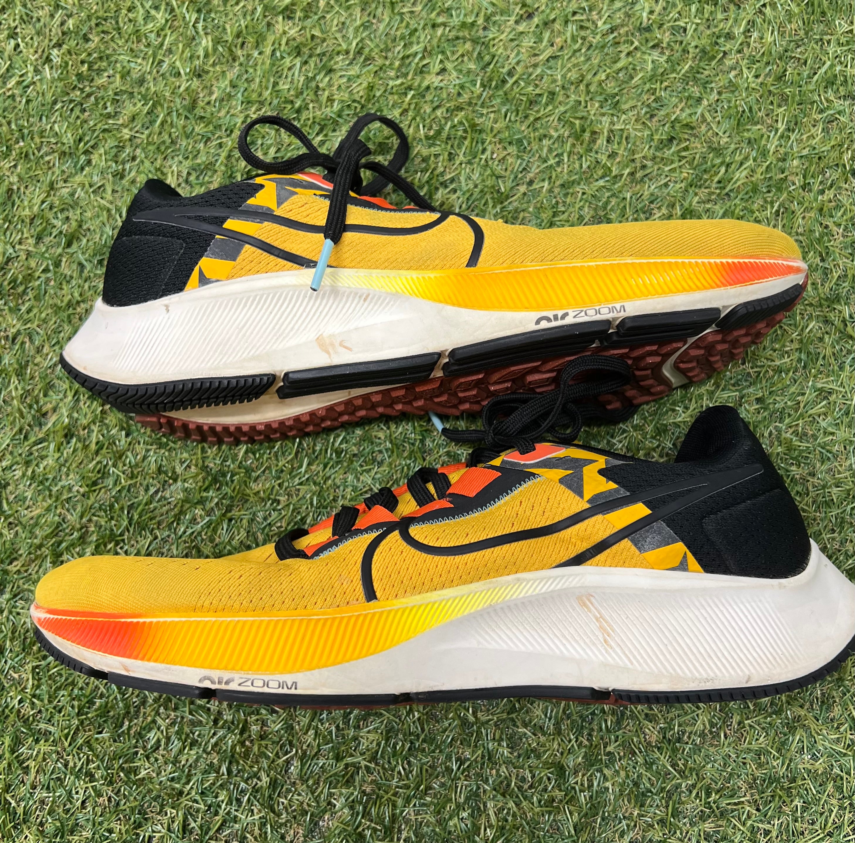 Side view of Nike Air Zoom Pegasus 38 trainers highlighting yellow upper and Air Zoom midsole