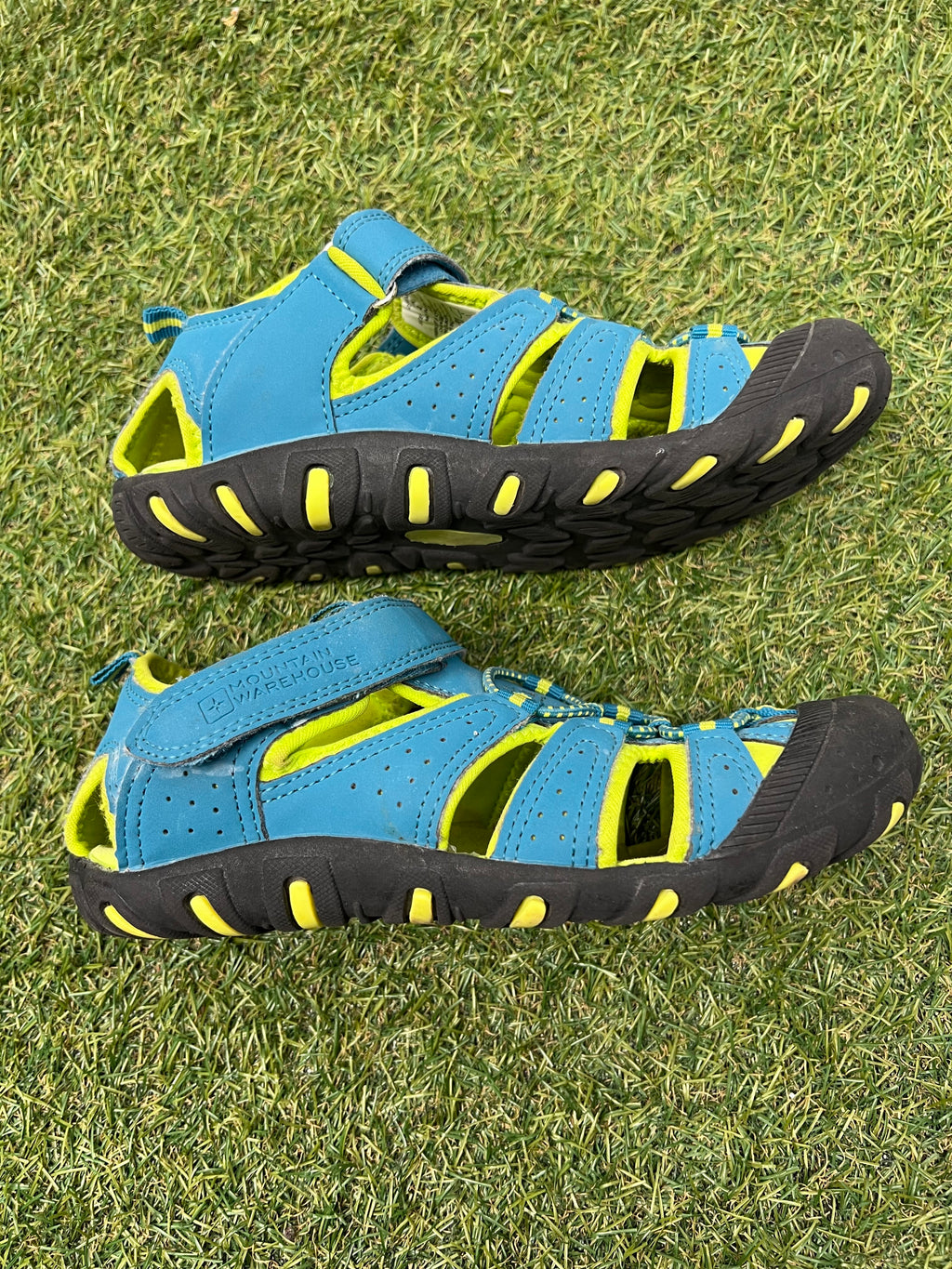 Side view of one blue and yellow children's water sandal showing breathable straps and sturdy toe cap