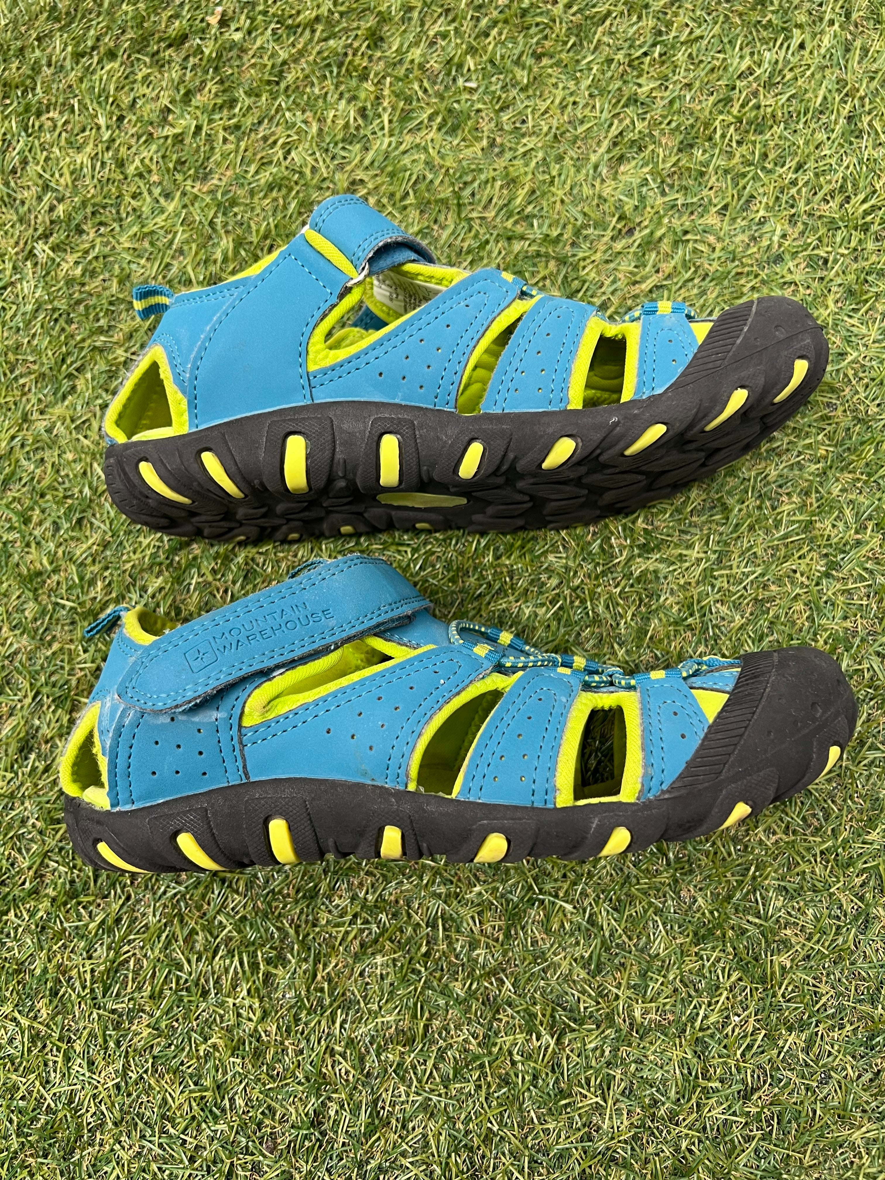 Side view of one blue and yellow children's water sandal showing breathable straps and sturdy toe cap