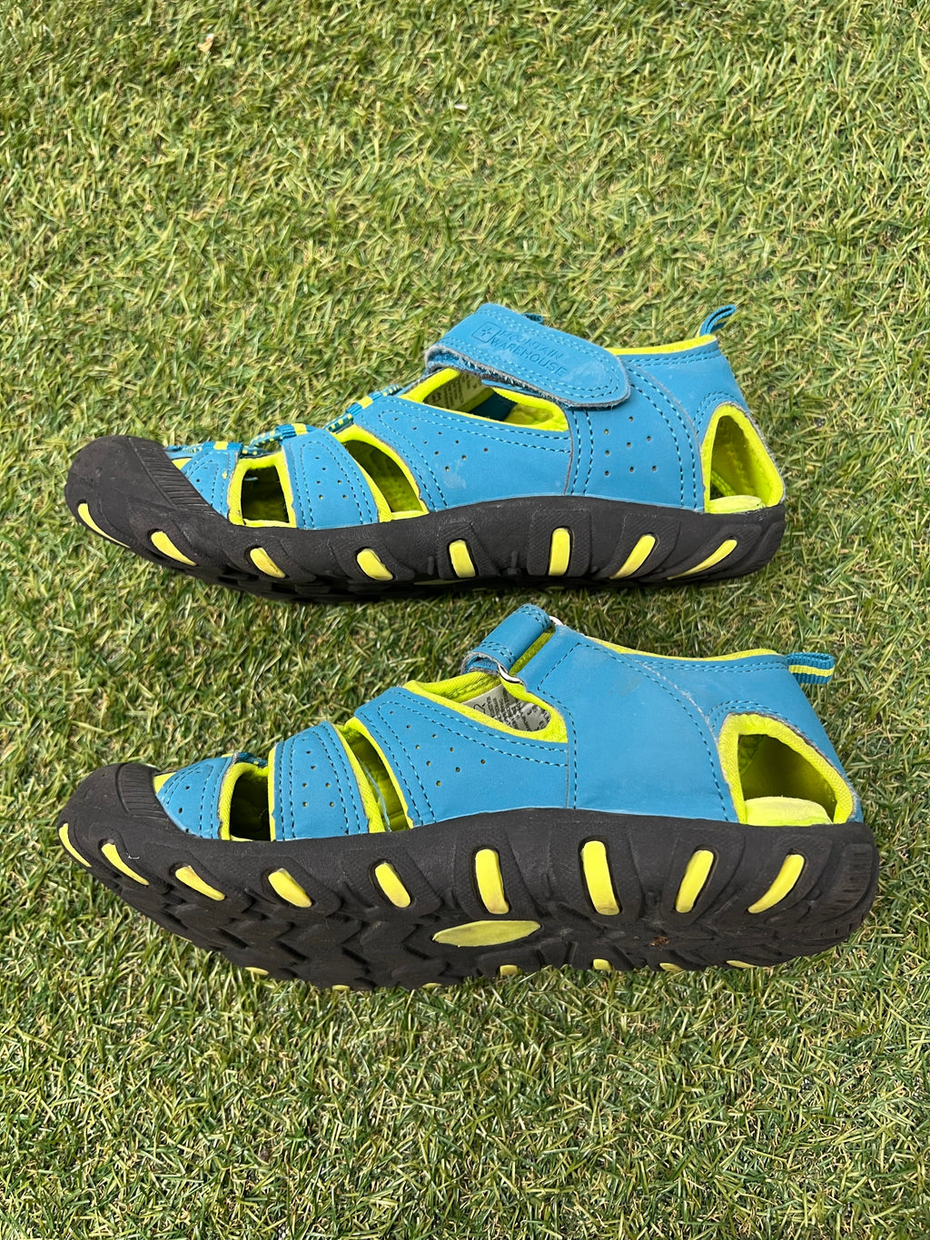 Opposite side view of a child's water sandal displaying thick sole and adjustable strap