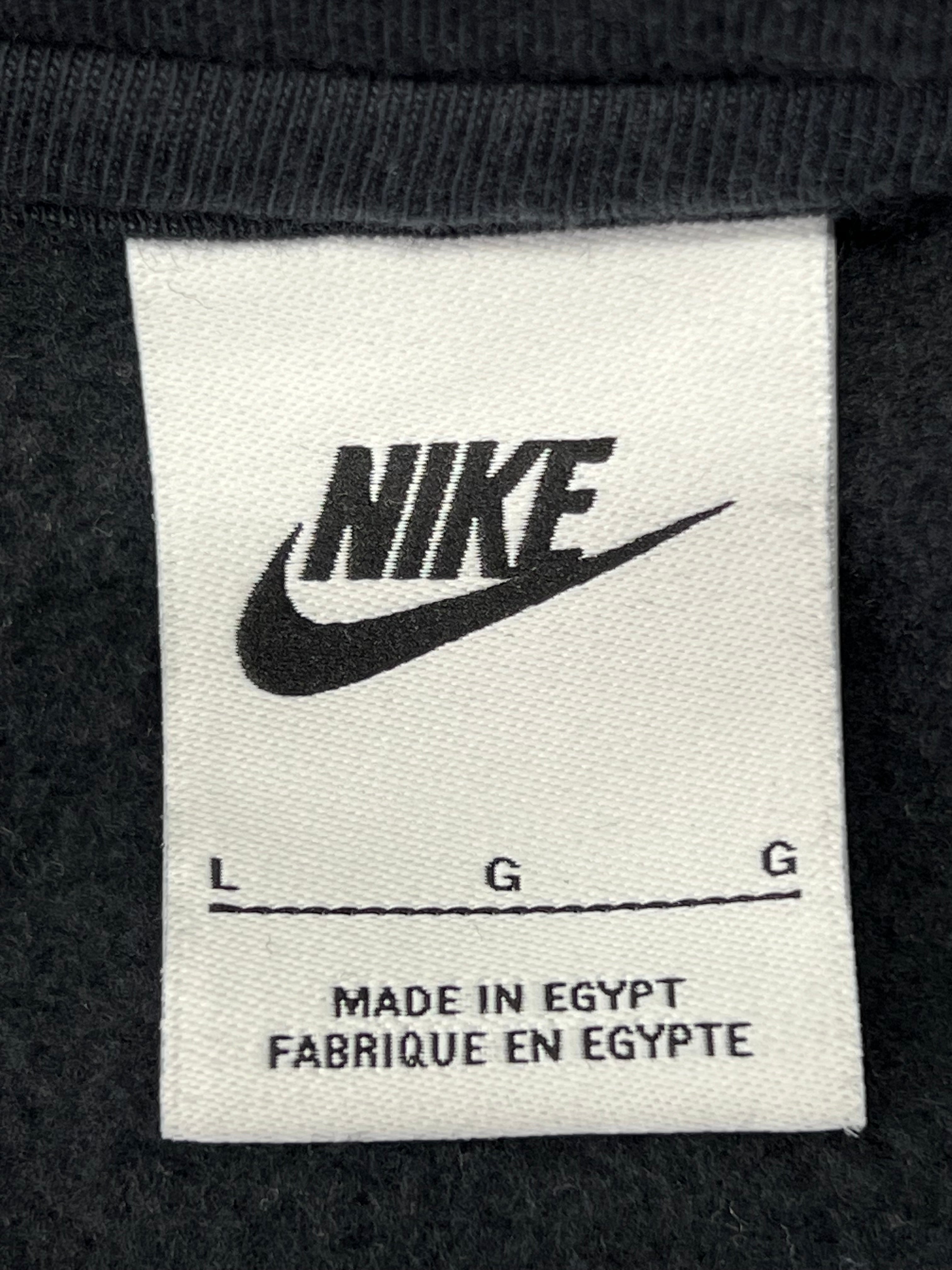 Close-up of Nike label inside hoodie showing size L and made in Egypt