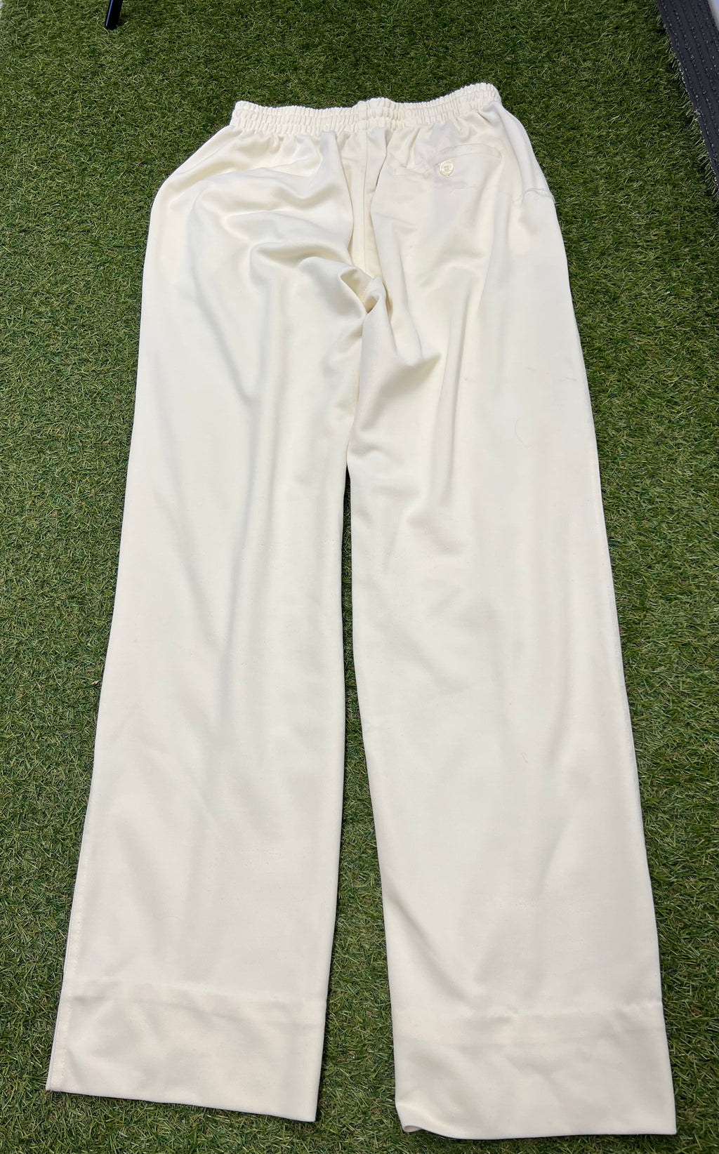 Back view of white Woodworm cricket trousers showcasing elastic waistband and rear pocket