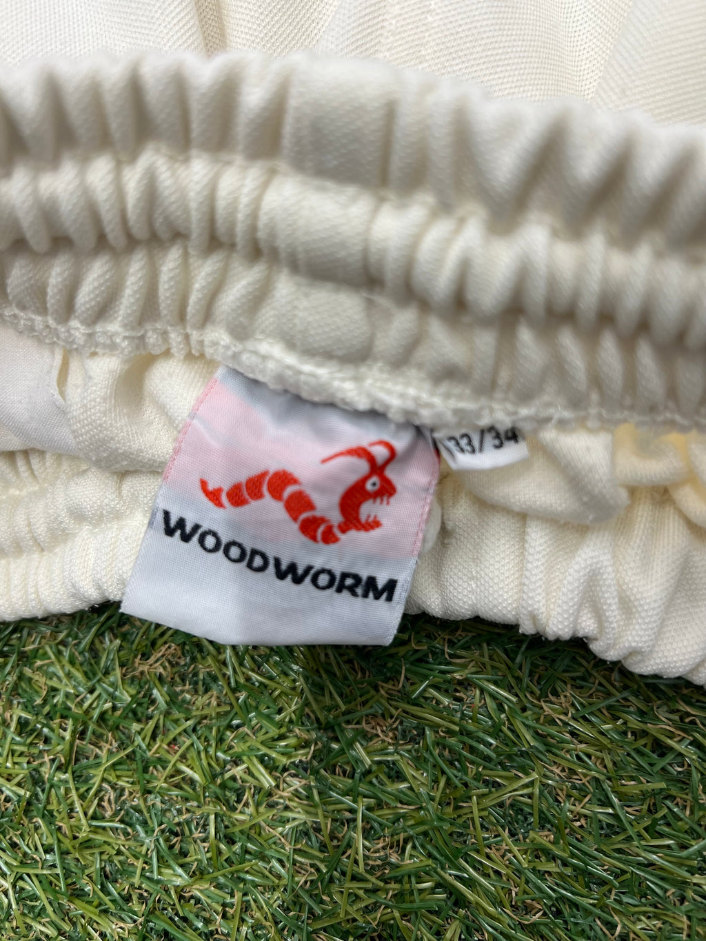 Close-up photo of Woodworm size label and elastic waistband inside cricket trousers