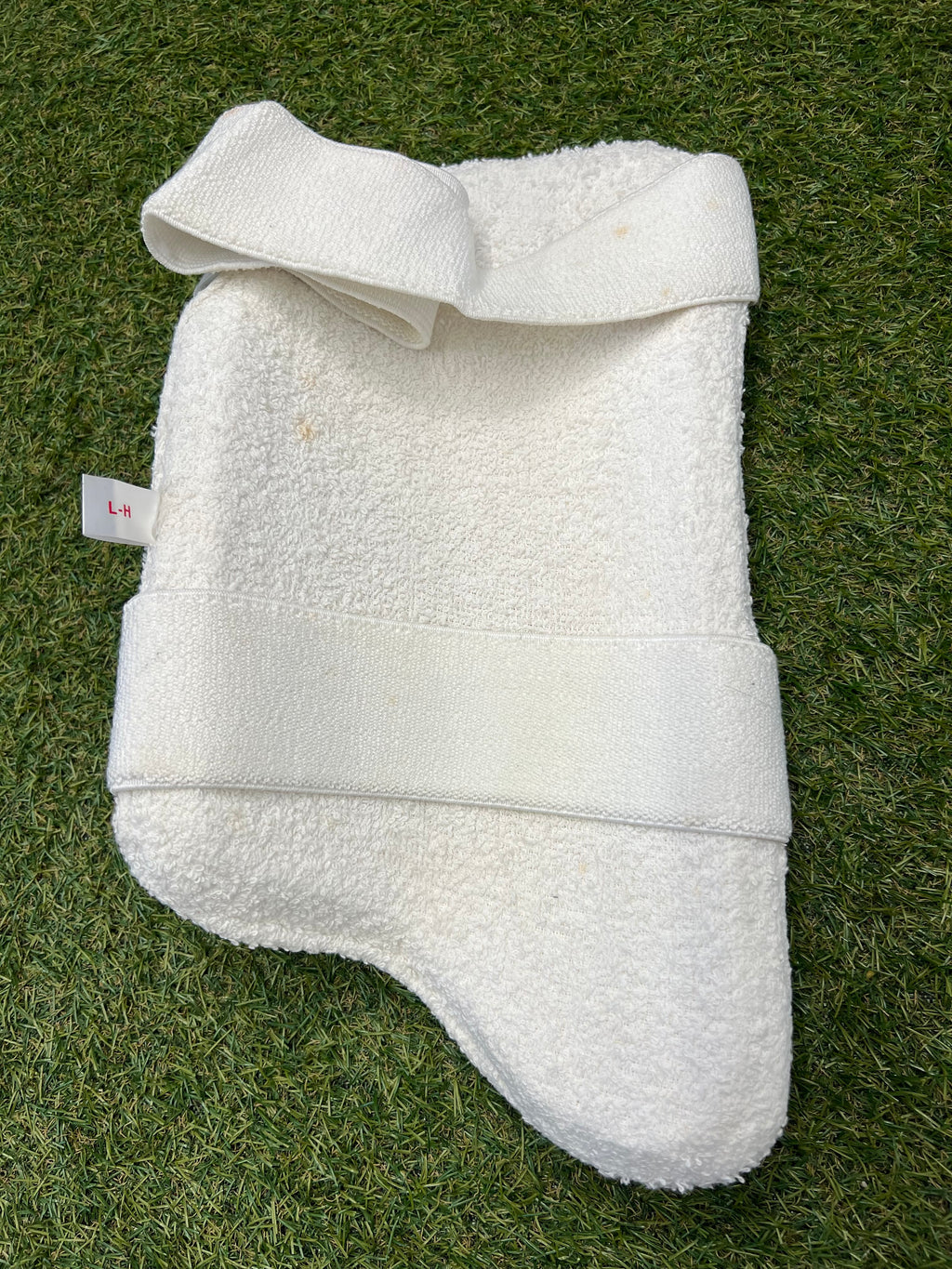 Reverse side of the Men’s Shark Hammerhead thigh pad showing white terry cloth lining and elastic strap
