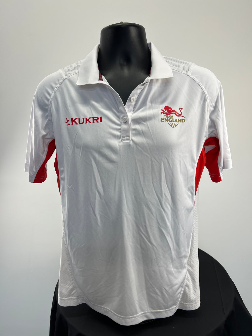 Front view of Team England women's white polo shirt with red side panels and logos
