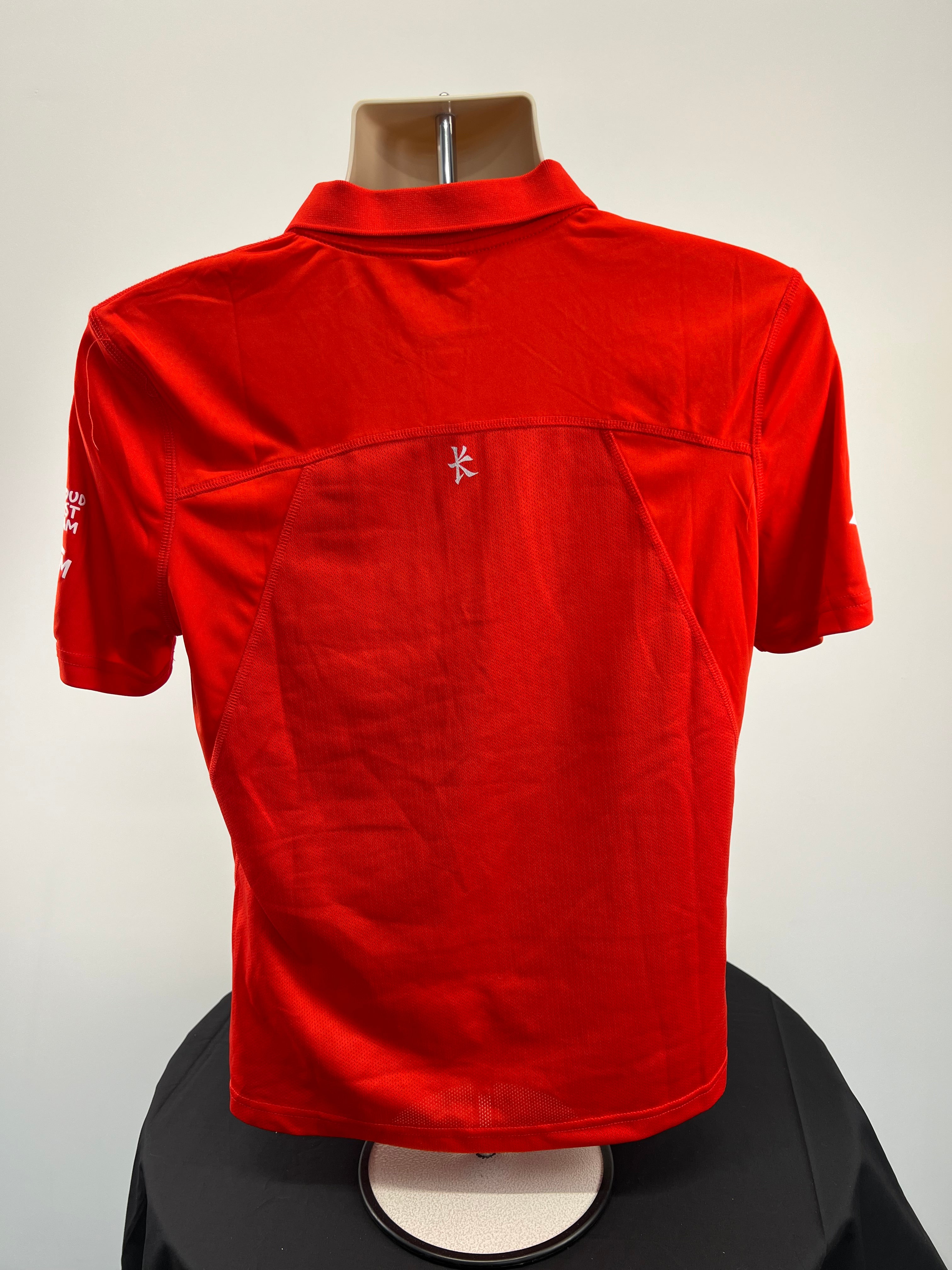 Back view of red Kukri women's polo shirt showing stitching detail and fabric texture