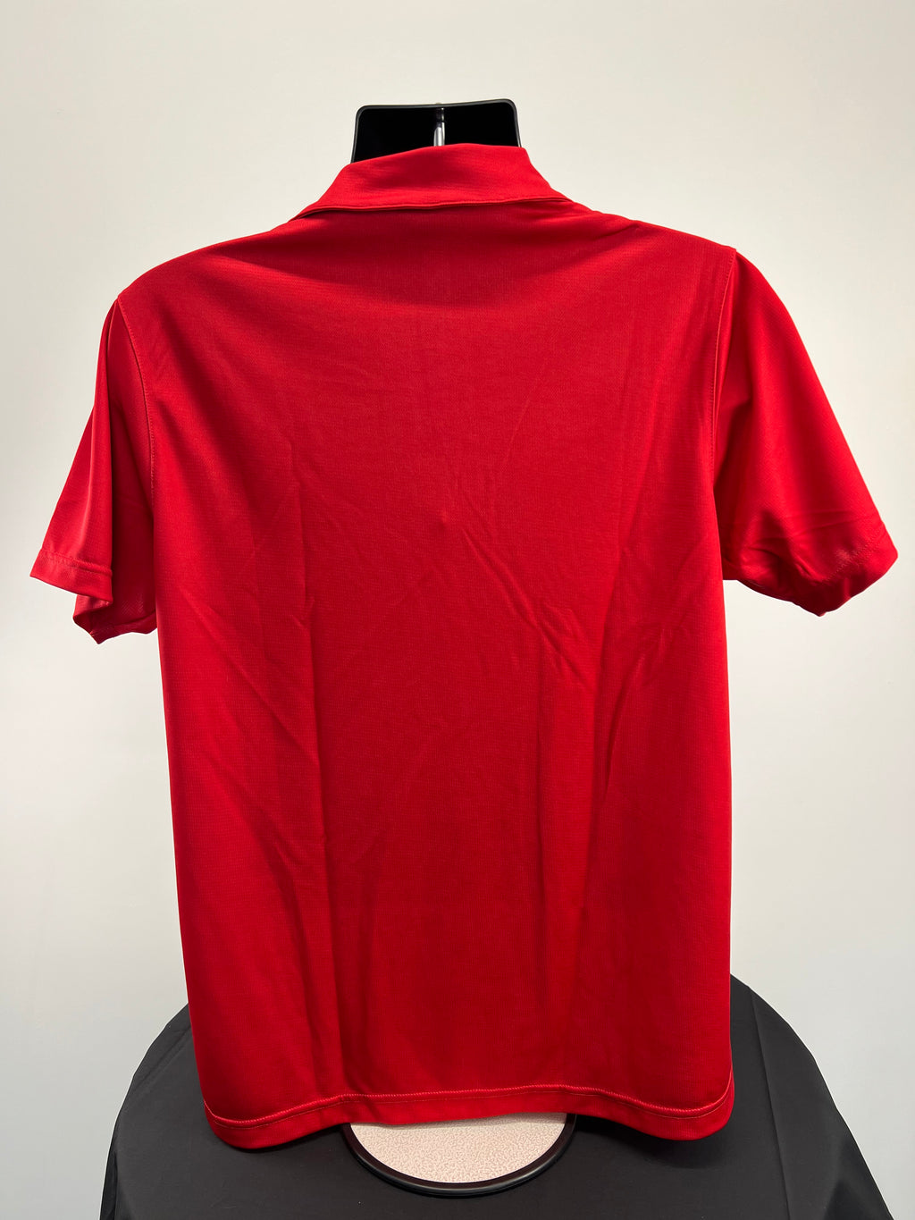 Back view of plain red Kukri polo shirt showing short sleeves and collar