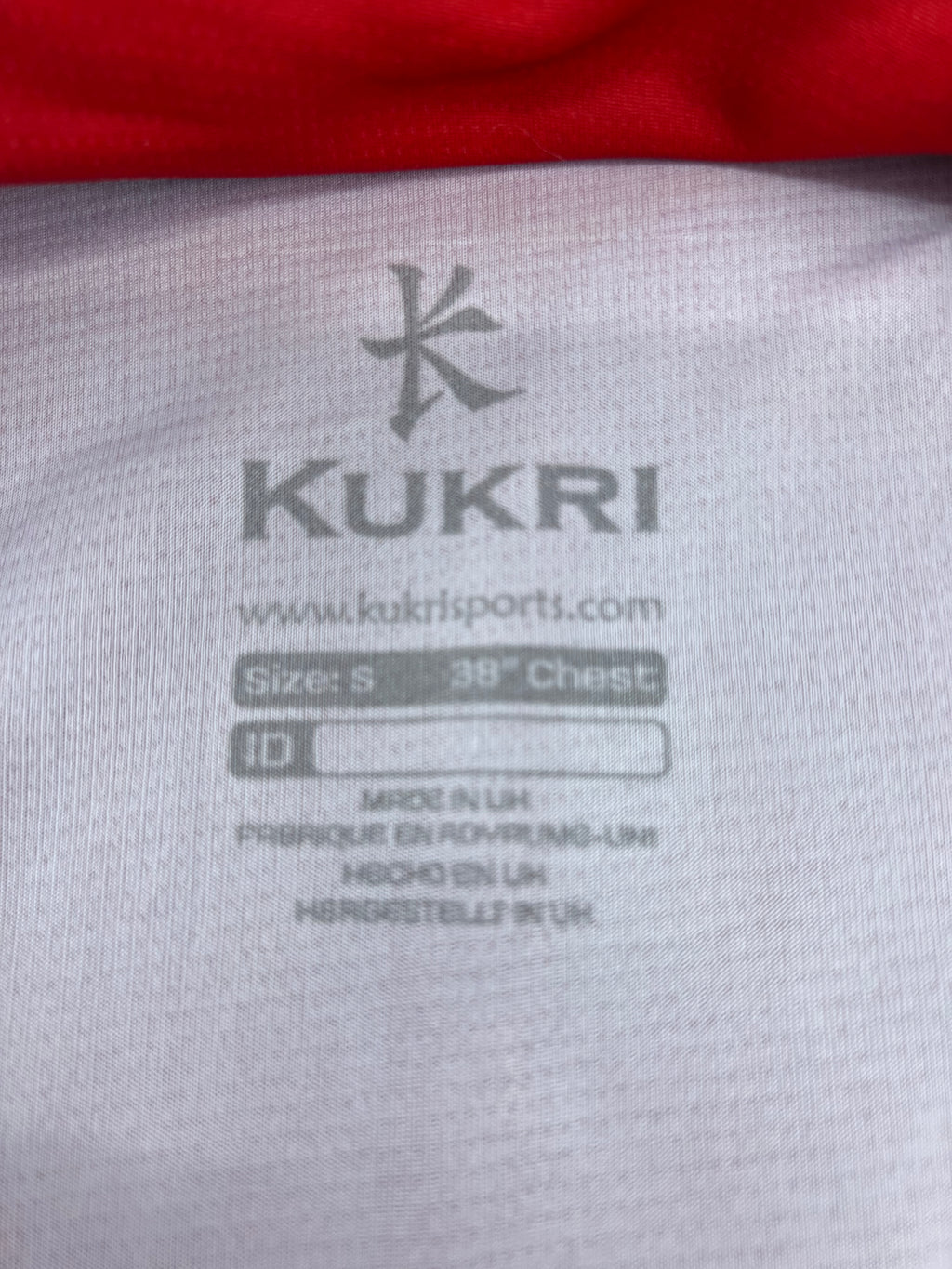 Close-up of inside label showing Kukri branding, size S 38 inch chest, and made in UK