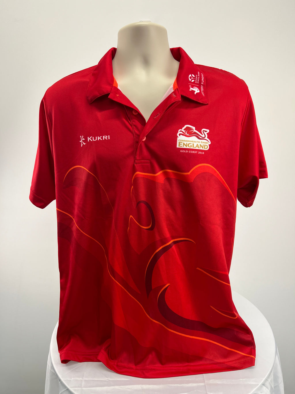 Front view of men's red Team England Commonwealth Games polo shirt with logos and design accents