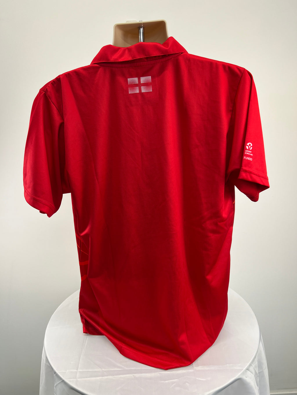 Back view of men's red Team England Commonwealth Games polo shirt showing England flag detail