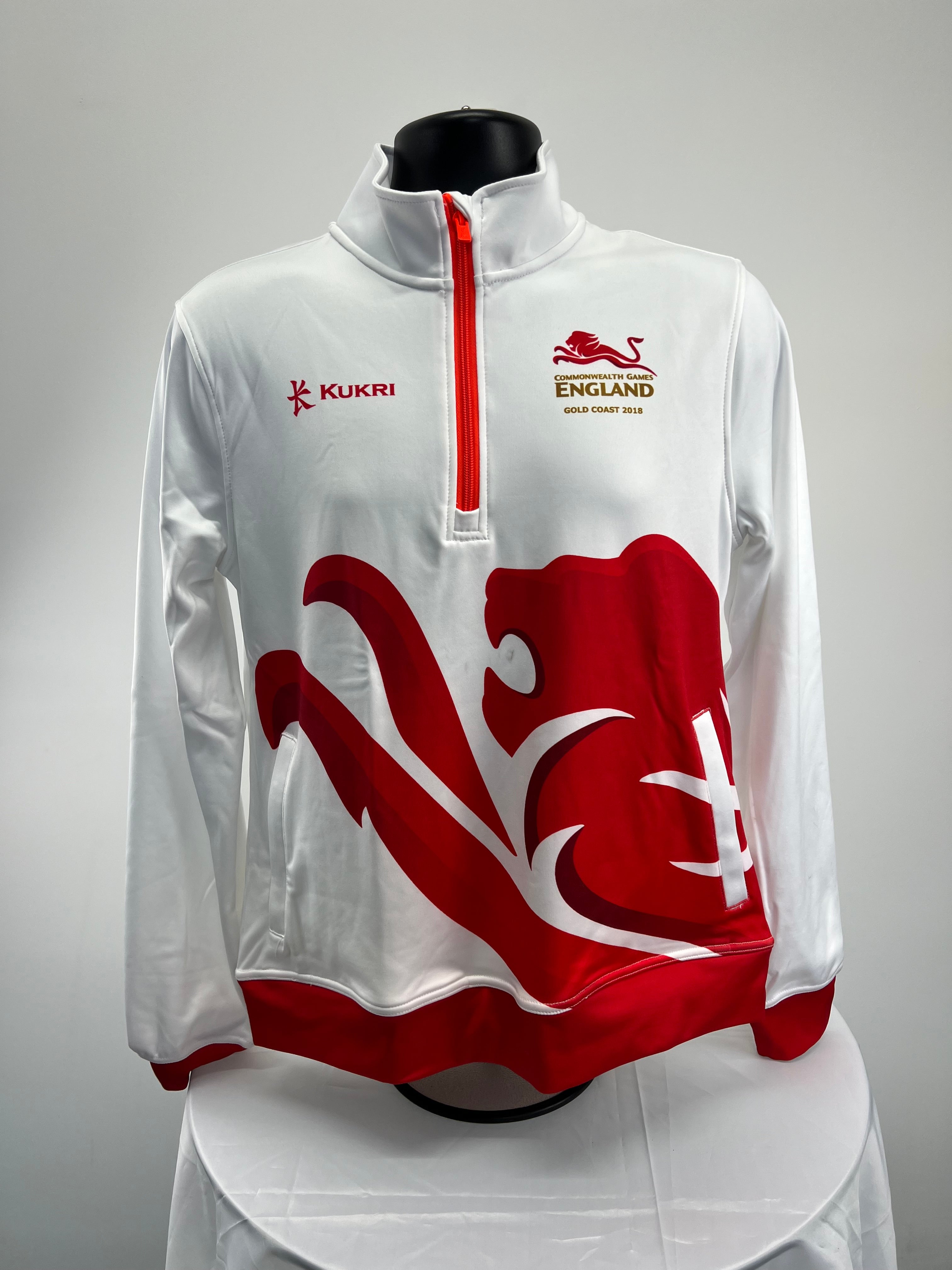 Front view of Team England women's white 1/2 zip top with red lion graphic and Commonwealth Games logo