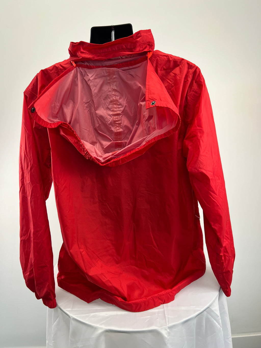Back view of red Kukri jacket showing interior lining and collar with snap buttons