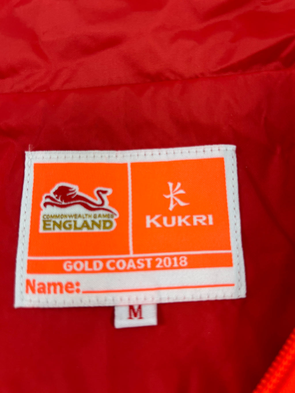 Close-up of inner label featuring Team England Commonwealth Games 2018 and Kukri branding with size M
