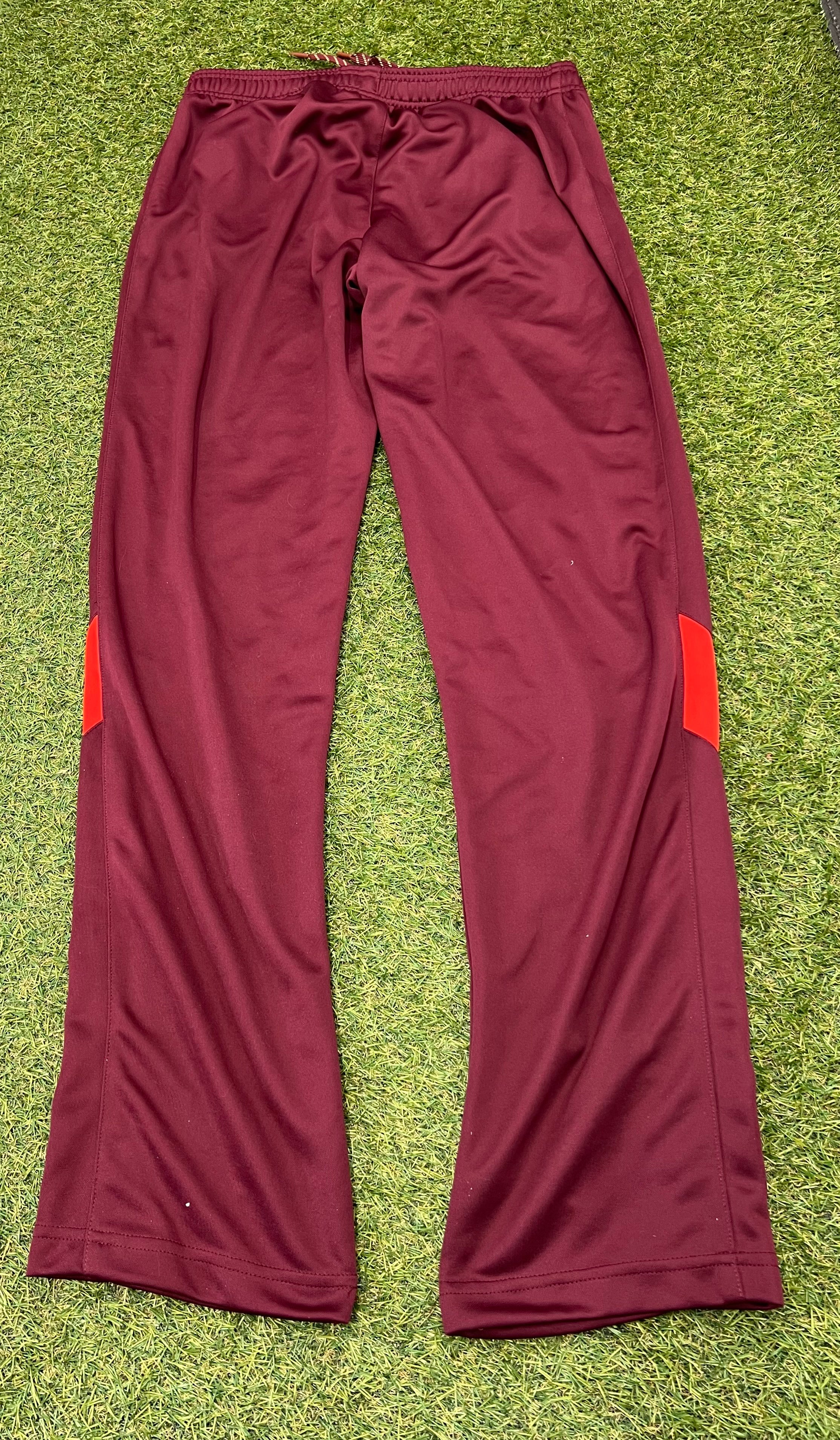 Back view of maroon tracksuit bottoms with red panels on the legs
