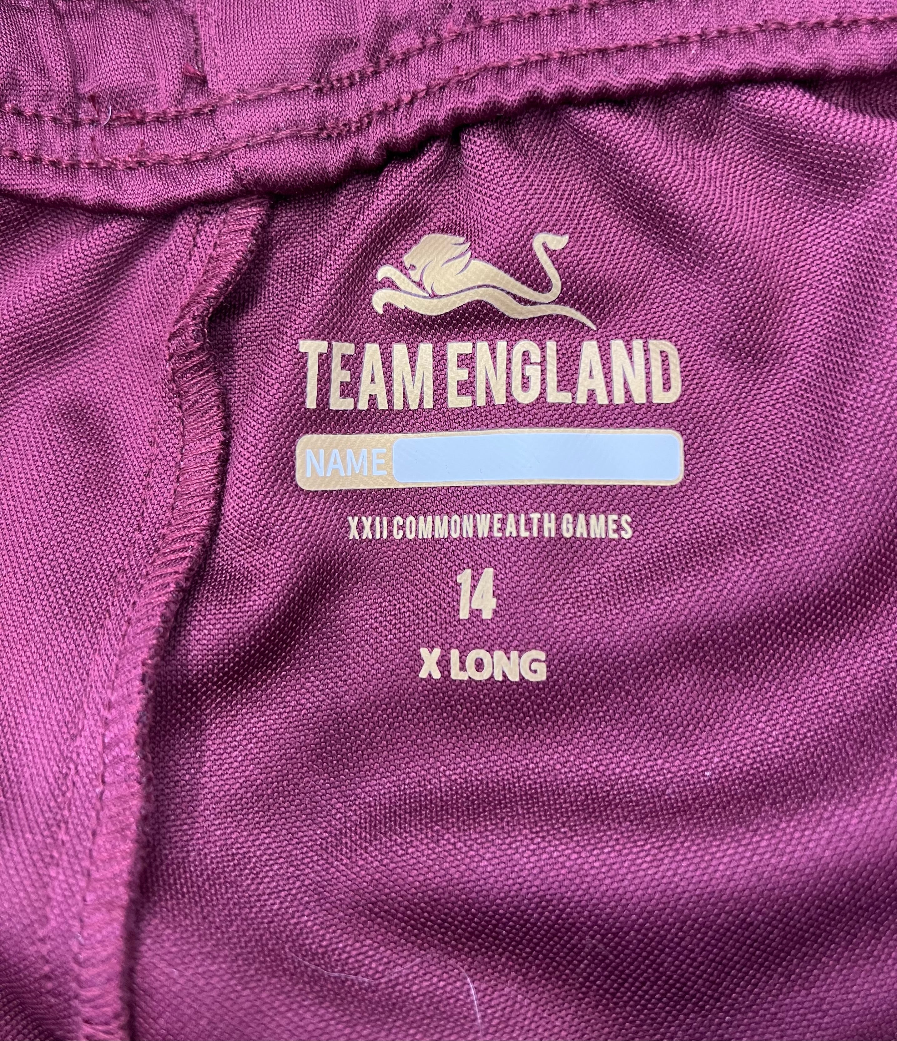 Close-up of Team England logo and size markings on the inside waistband of the tracksuit bottoms