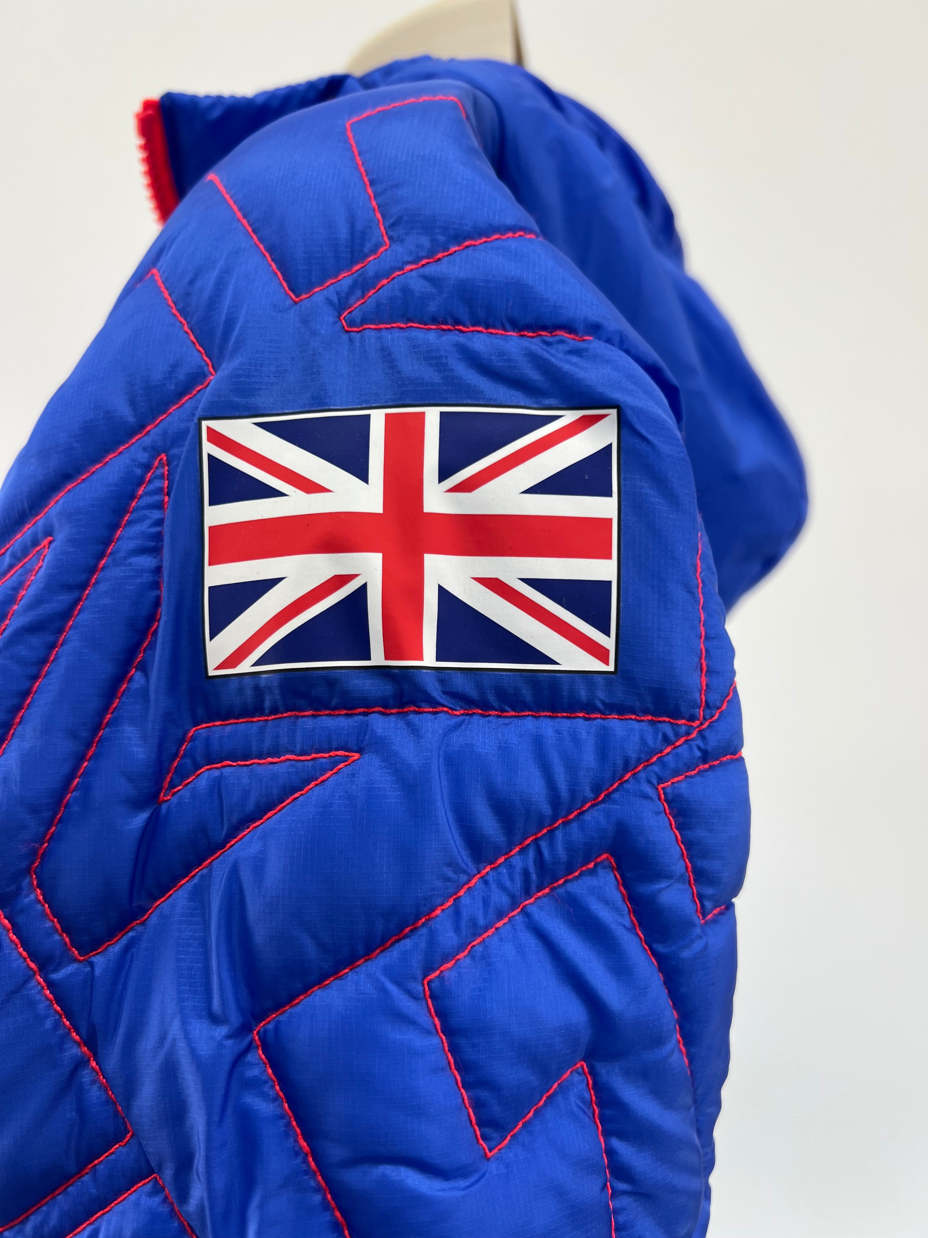 Close-up of Union Jack patch on the sleeve of blue puffer jacket