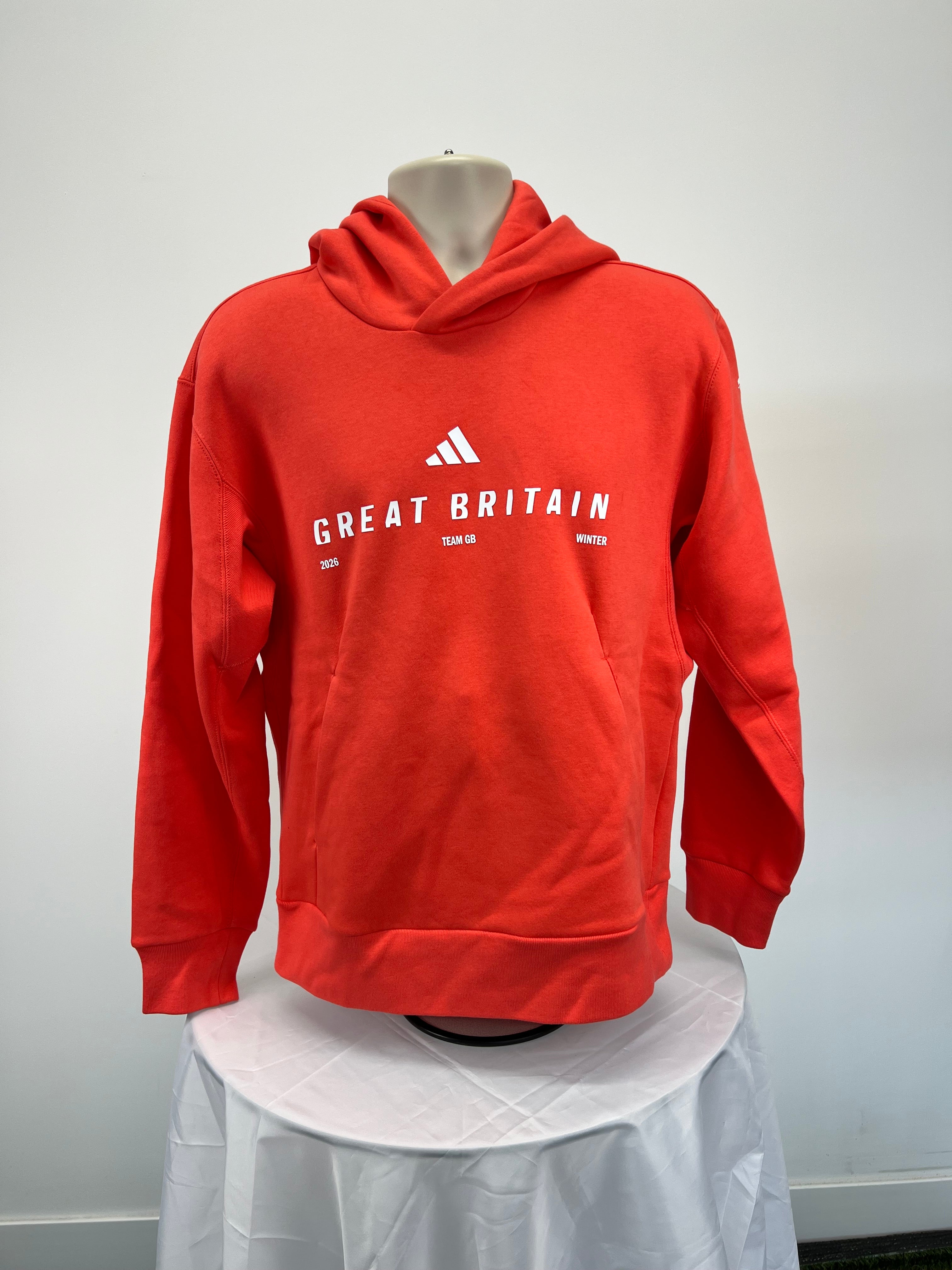 Front view of Adidas Team GB women's red hoodie with Great Britain and winter 2026 print