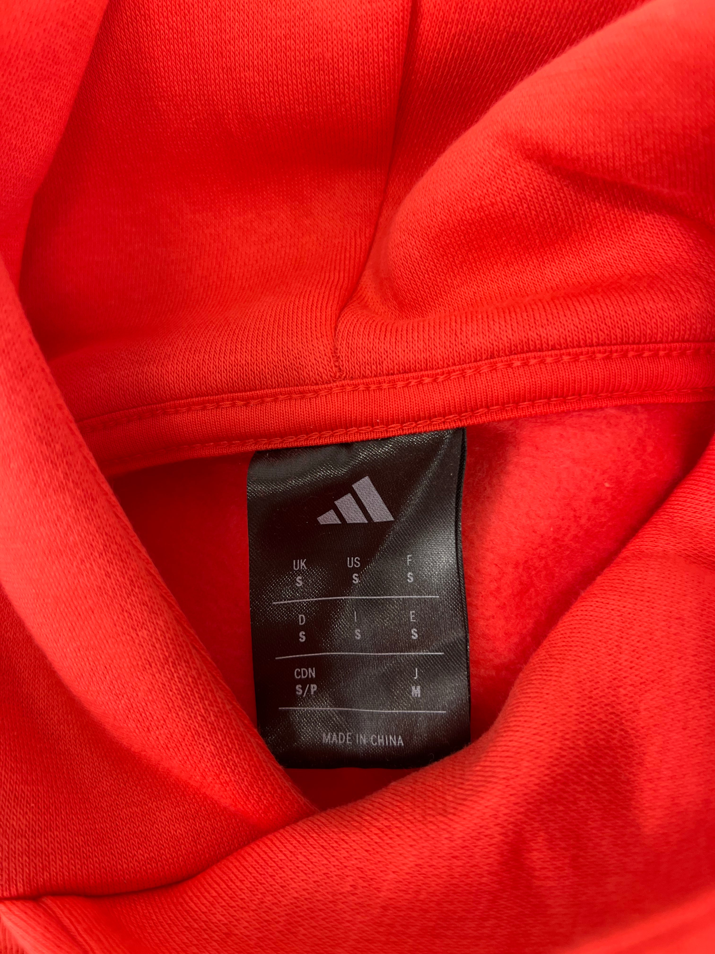 Label inside Adidas hoodie showing size small and made in China