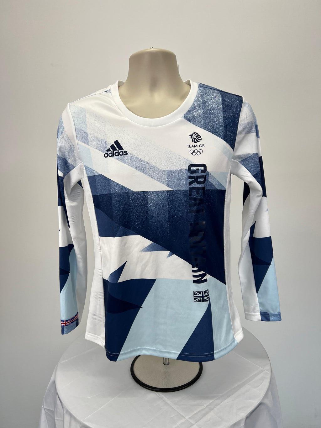 Front view of women’s adidas Team GB long sleeve top in blue and white geometric design with logos