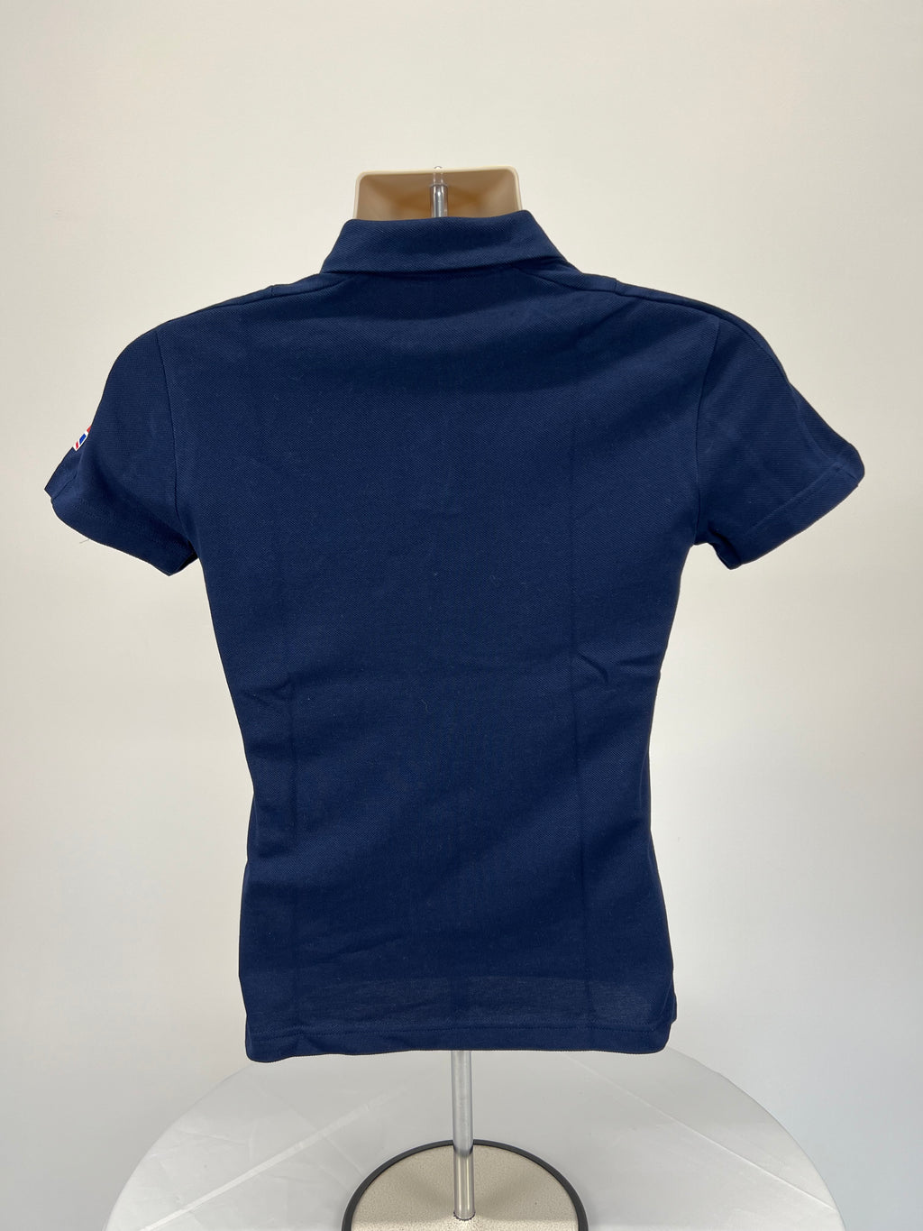 Back view of Adidas Team GB Beijing 2022 women's navy blue polo shirt showing plain design and collar