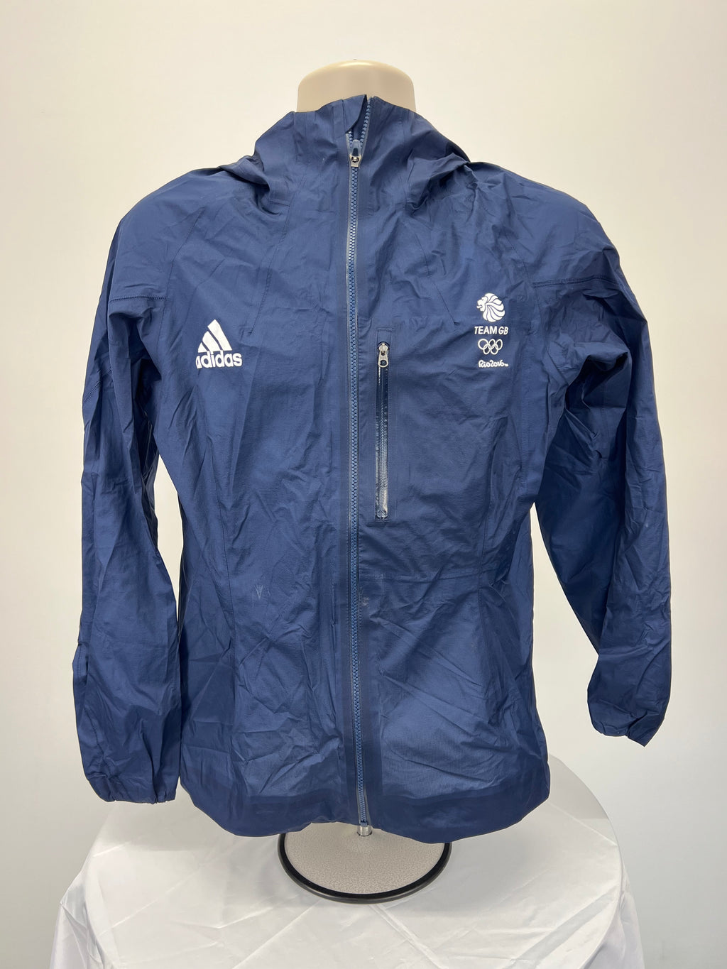 Front view of navy blue Adidas Team GB lightweight jacket with zip-up and chest pocket