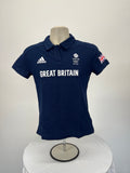 Front view of navy blue women's Team GB Tokyo 2020 polo shirt with white Great Britain text and Adidas logo