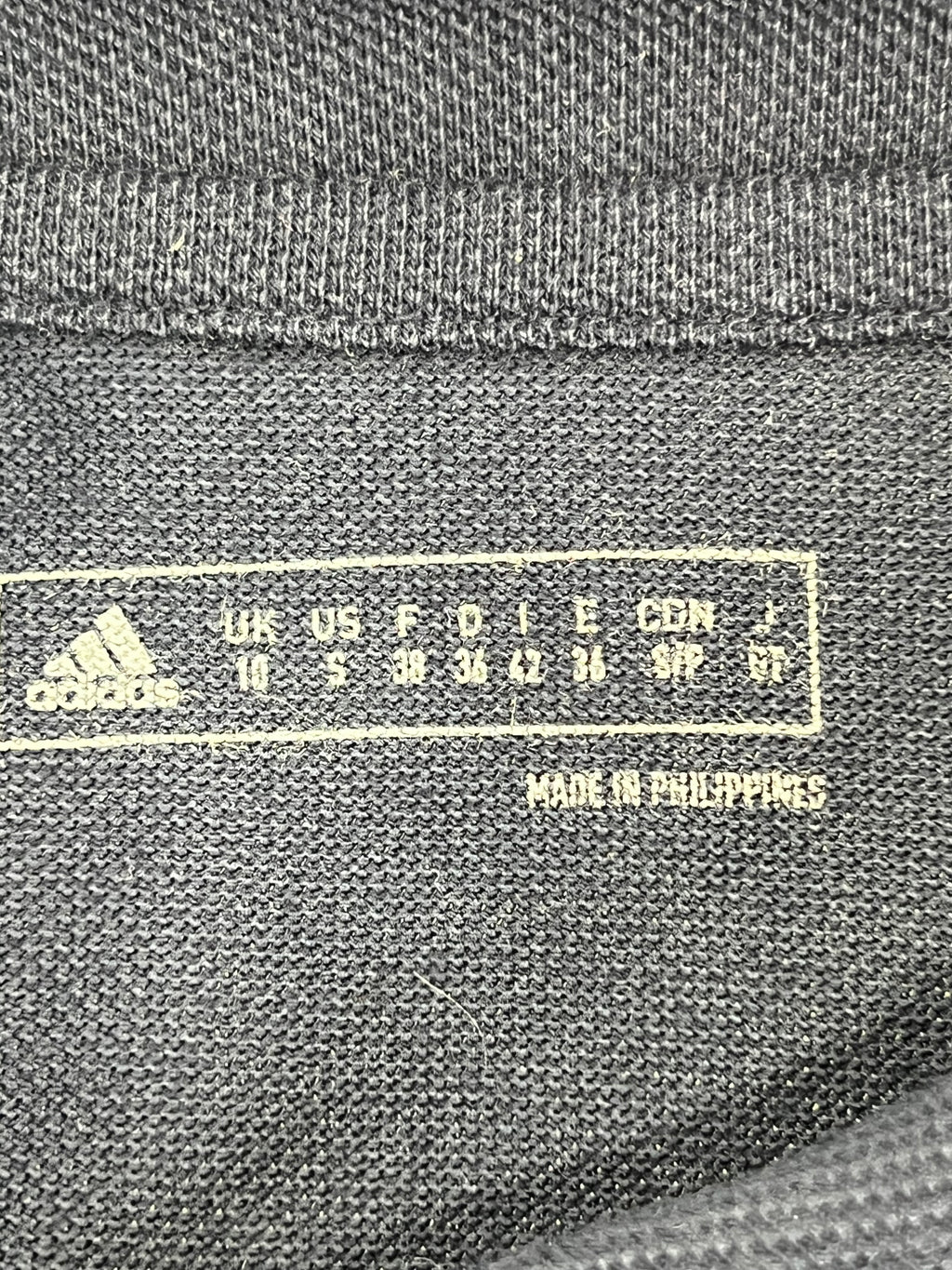 Inside label showing Adidas branding, size information and 'Made in Philippines' text