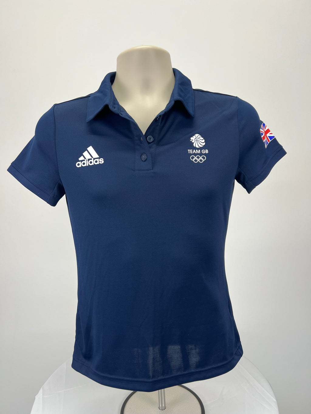 Front view of women's Adidas Team GB navy blue polo shirt with embroidered logos and button collar