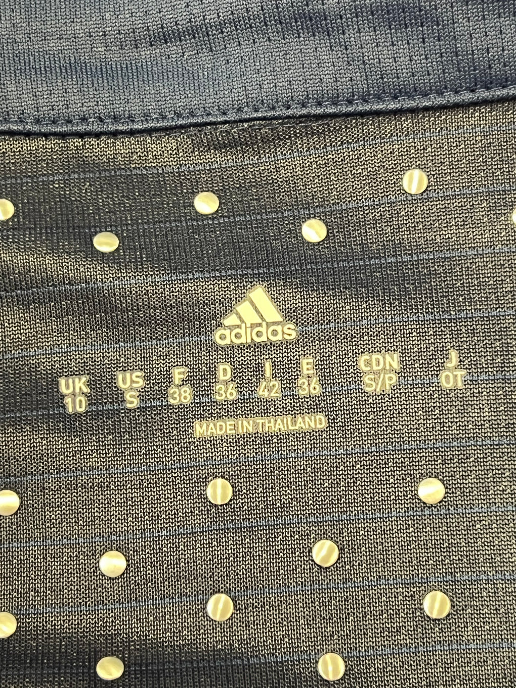 Label inside the polo showing size UK 10 / US S and made in Thailand on Adidas branded tag