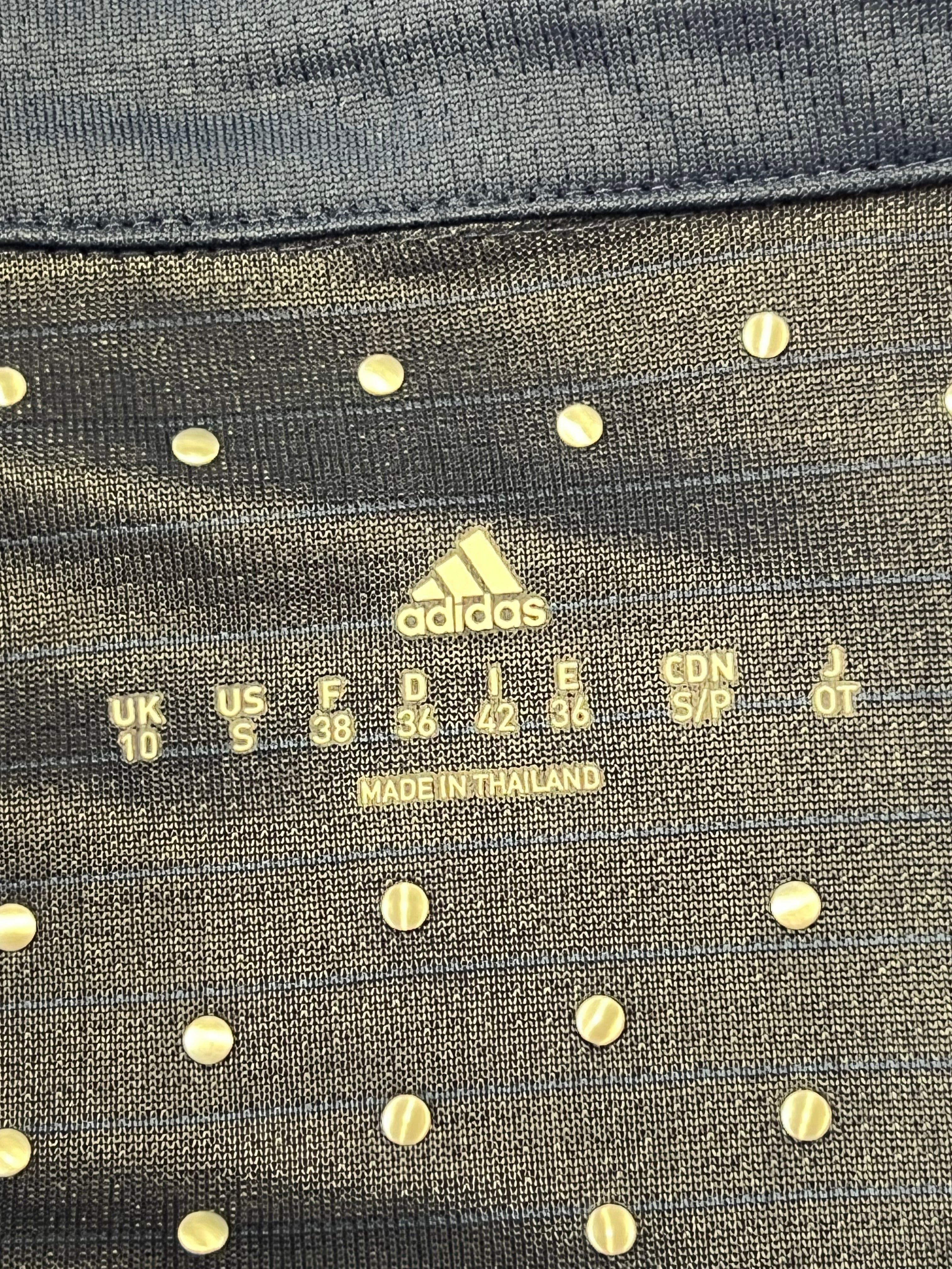 Label inside the polo showing size UK 10 / US S and made in Thailand on Adidas branded tag