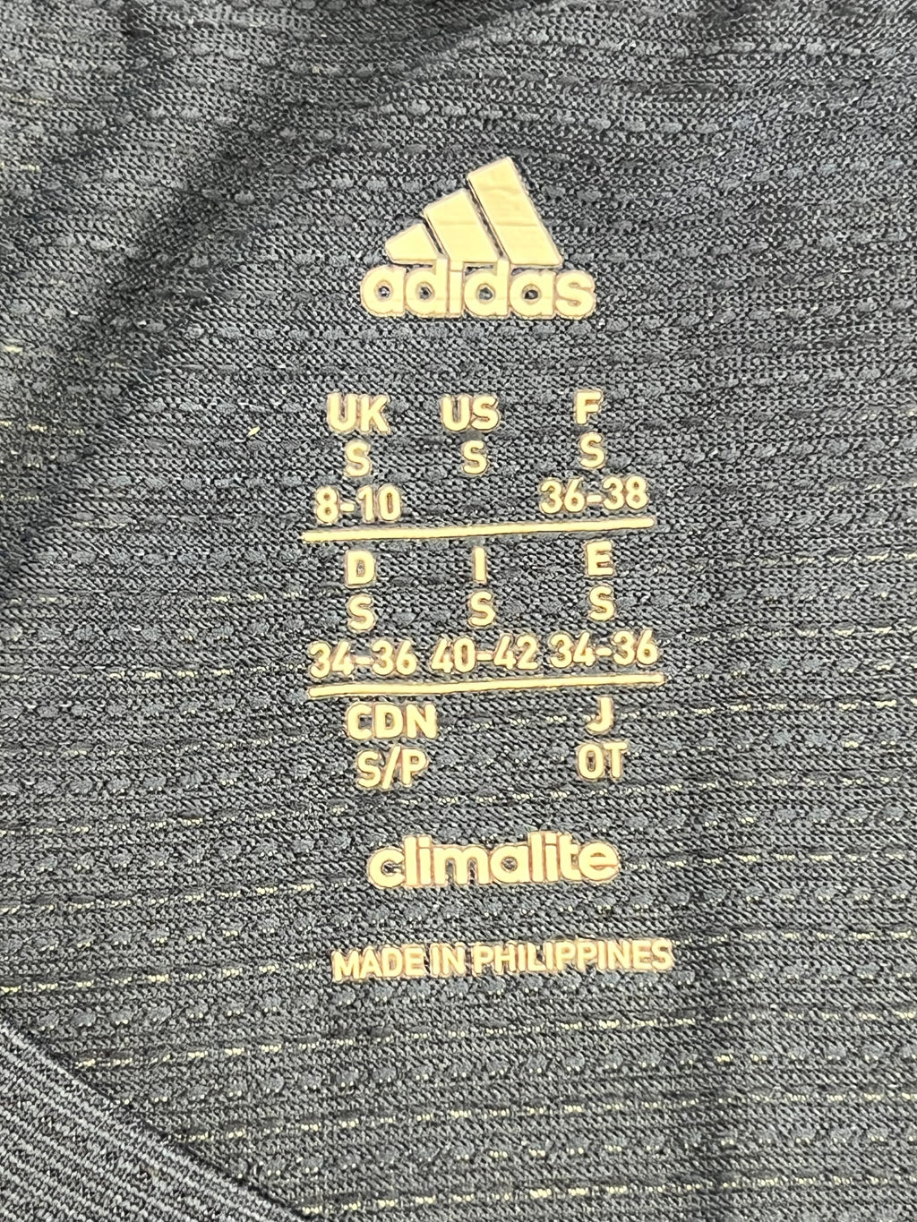 Adidas Climalite label and size information printed inside the women's t-shirt