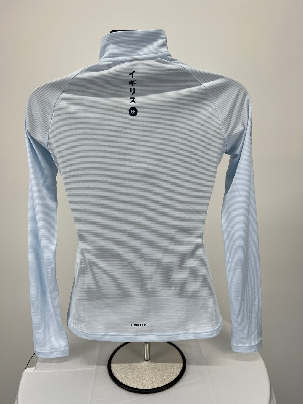 Back view of adidas Team GB light blue long sleeve quarter zip top showing Japanese lettering and 'AEROREADY' branding